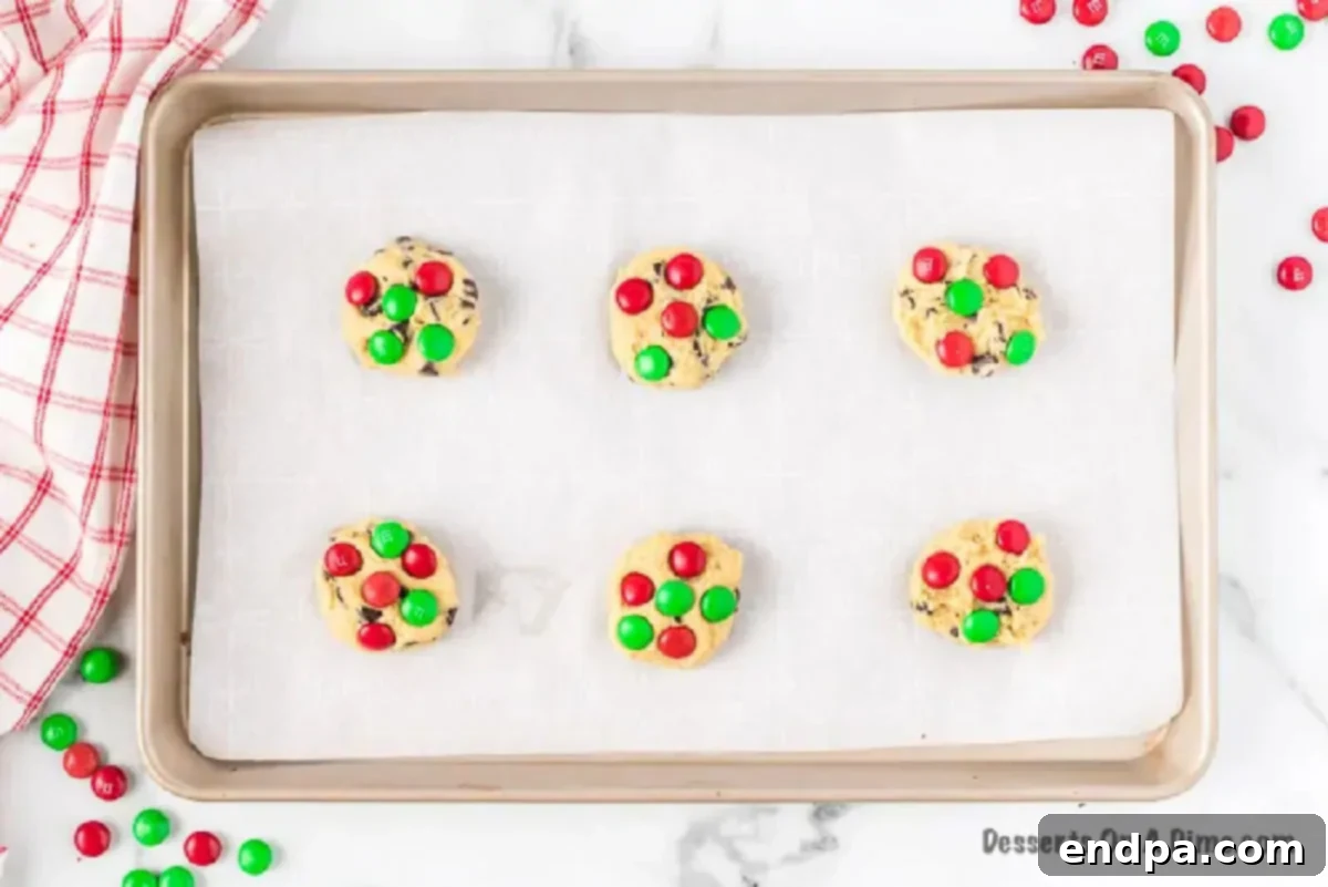 Deliciously Simple Santa Cookies 4 Pressing Christmas M&Ms onto freshly rolled cookie dough balls before baking