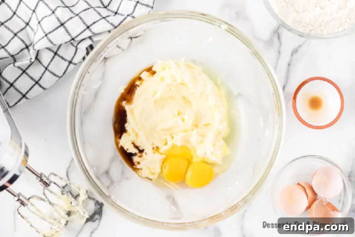 Butter, sugar and eggs in a mixing bowl being combined.