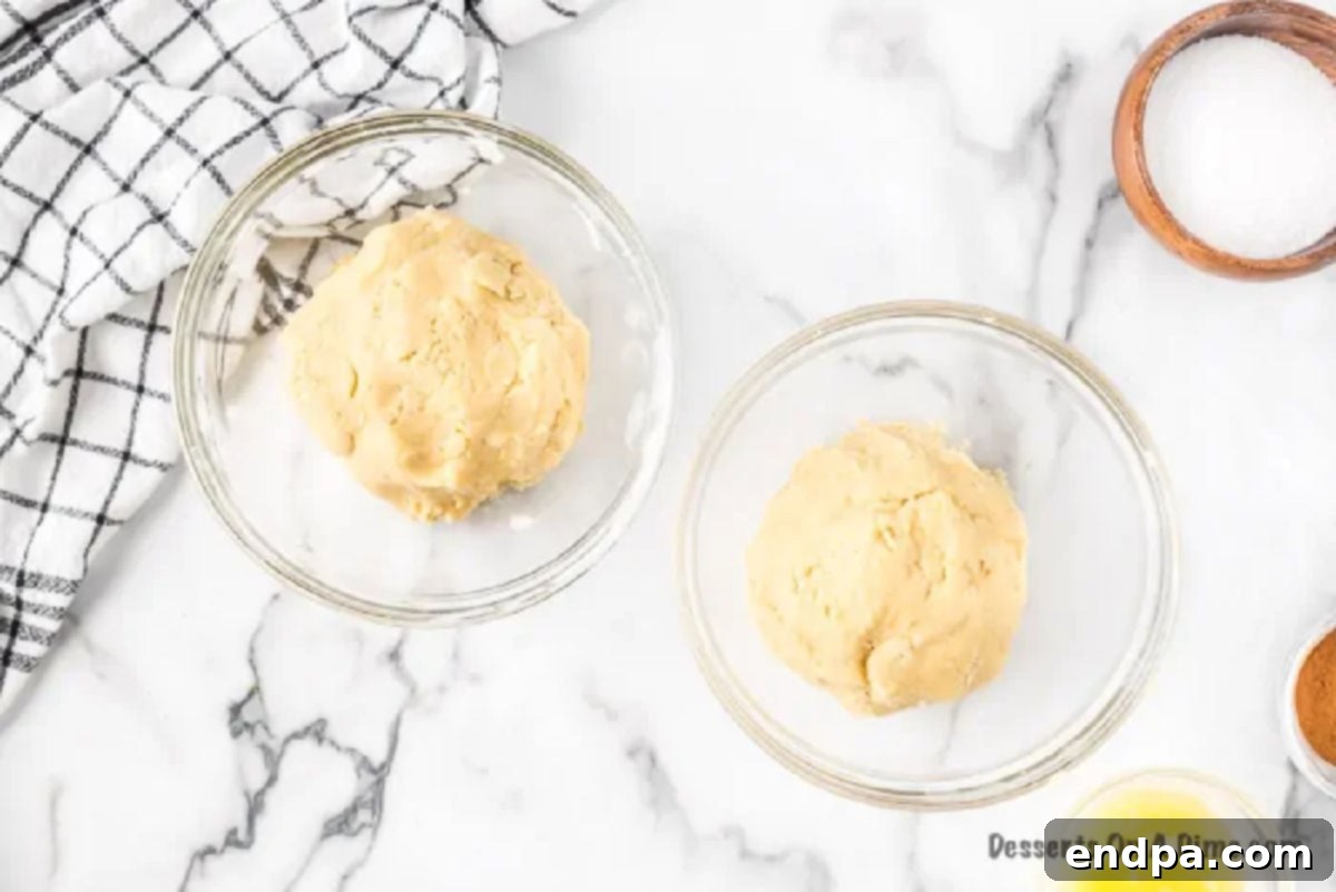 Cookie dough divided into two separate bowls.