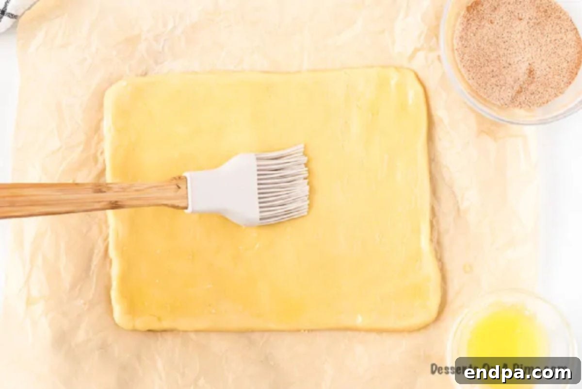 Melted butter spread thinly over the rolled-out dough.