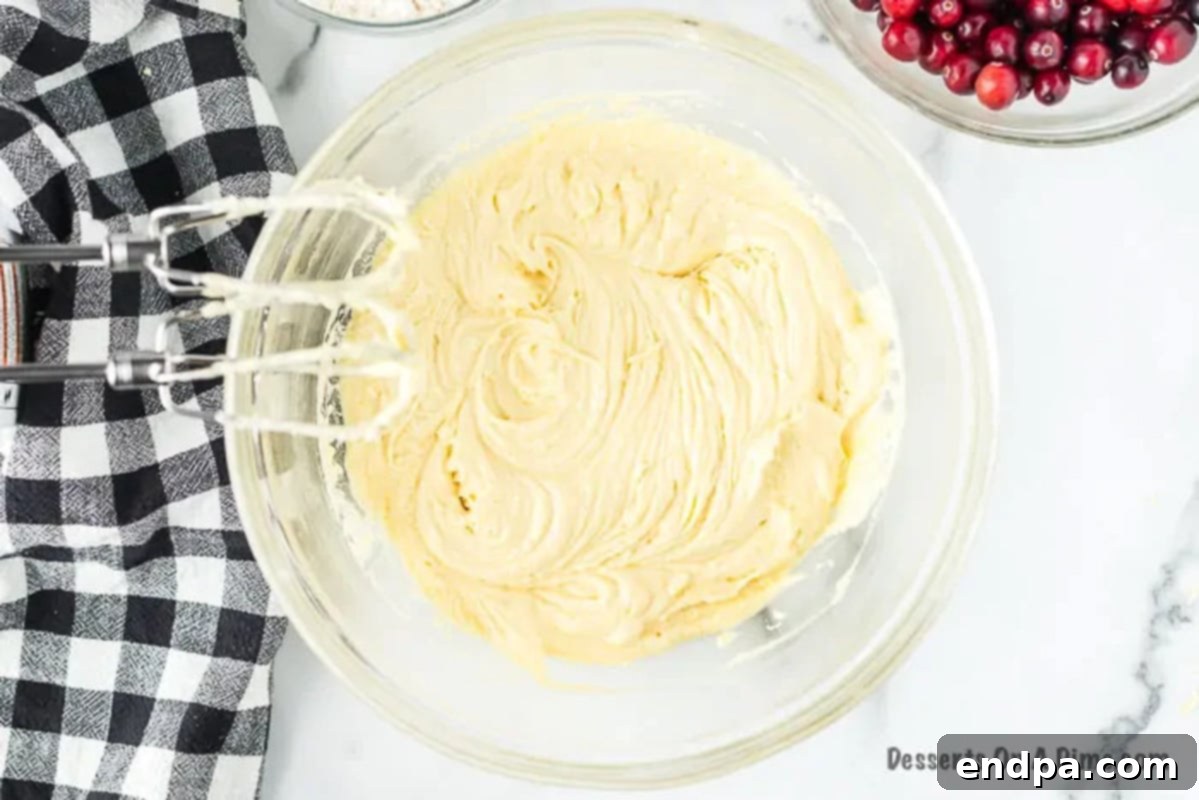 Mixing bowl with butter and eggs mixed together.