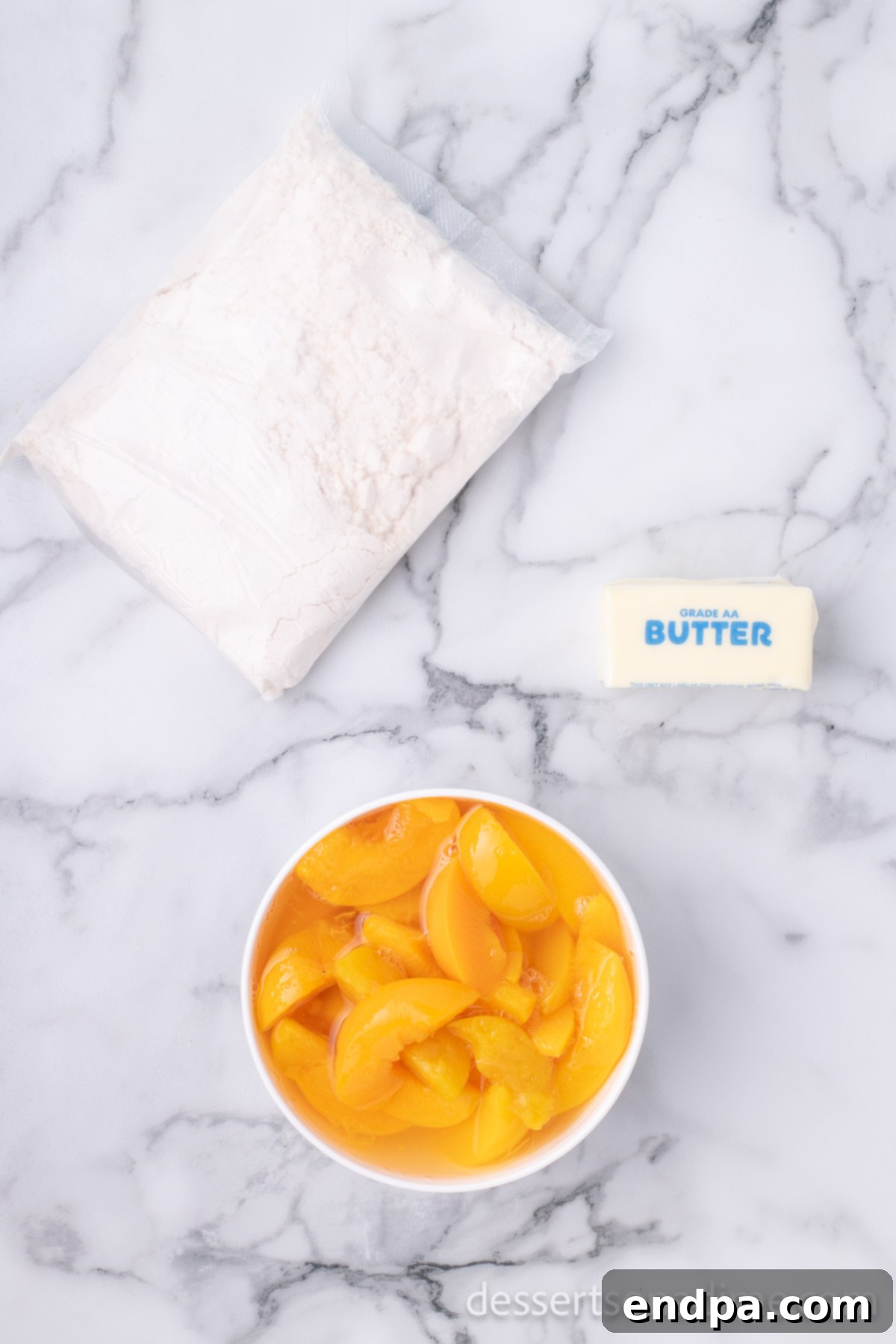 The three essential ingredients for a delicious dump cake: canned peaches, a box of yellow cake mix, and melted butter.