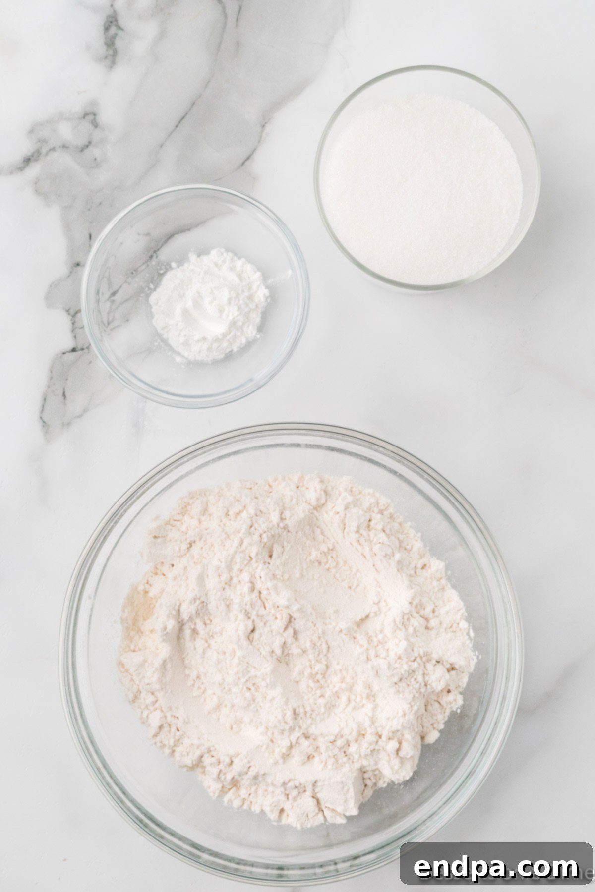 A mixing bowl with all the dry ingredients for the cake mix being combined.
