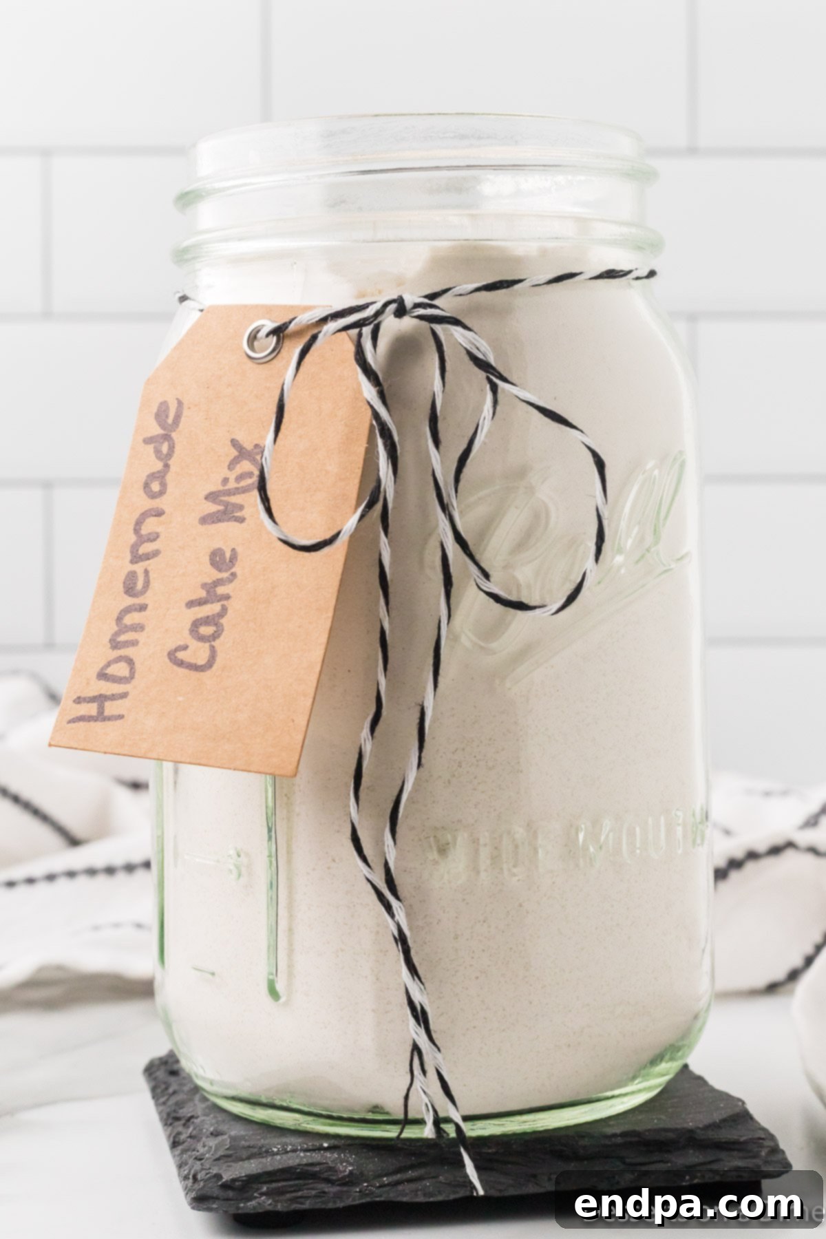 Close-up of a mason jar with dry ingredients for homemade cake mix.