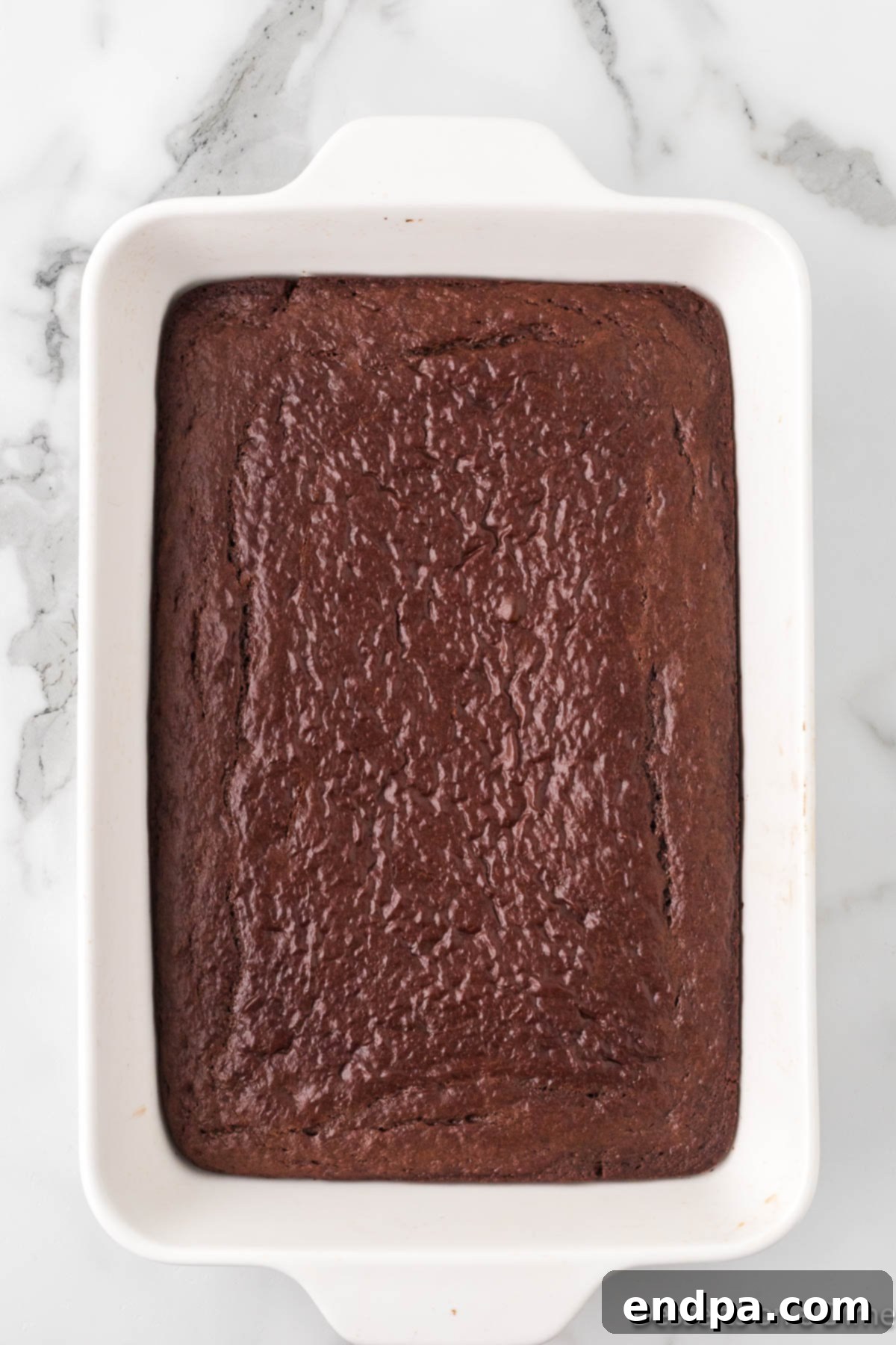 Gooey Chocolate Caramel Poke Cake 4 Cake baked and cooling in pan.