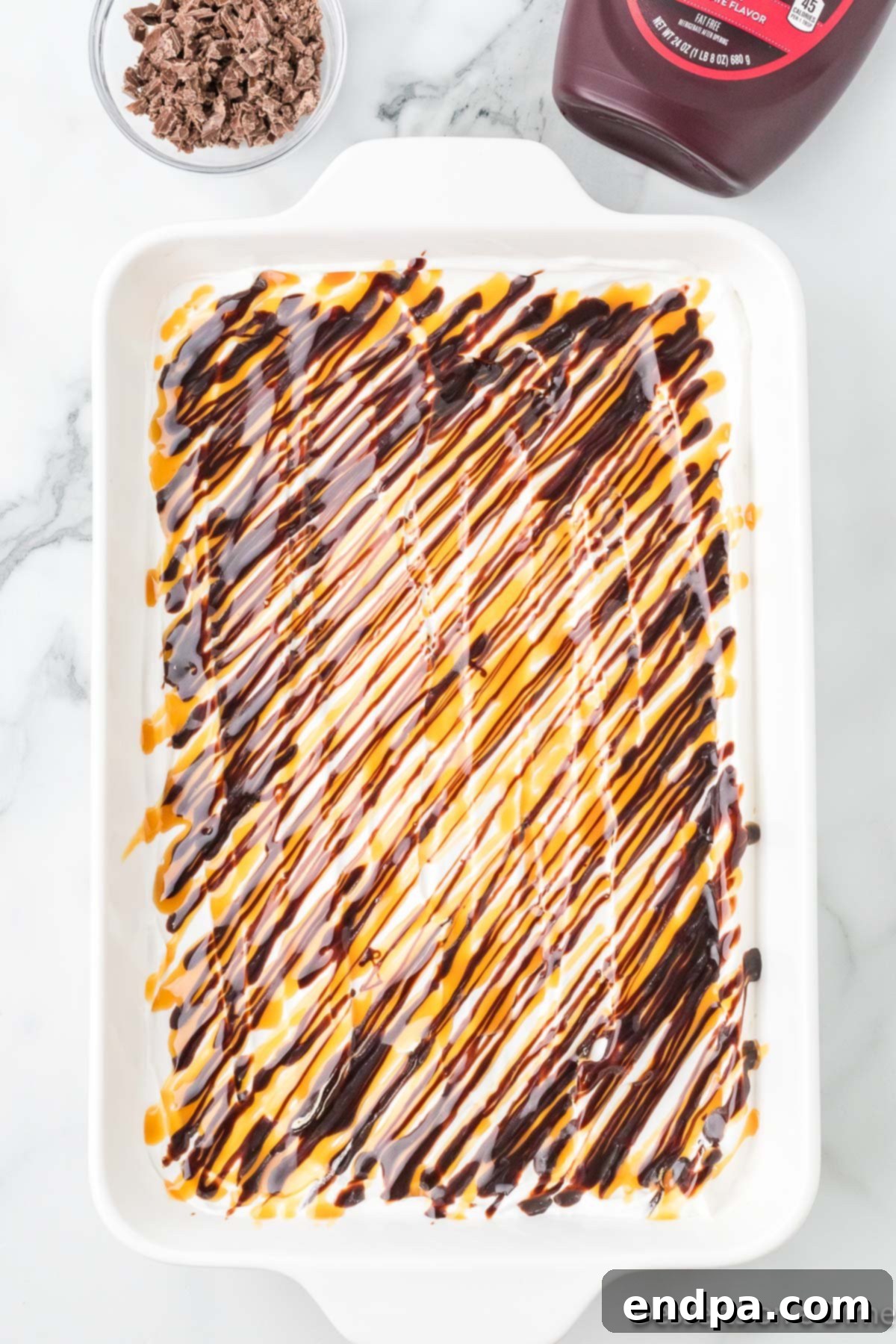 Gooey Chocolate Caramel Poke Cake 8 Chocolate and caramel swirled on top of cake.