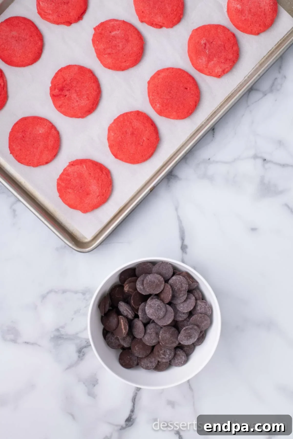 Dark Chocolate-Dipped Peppermint Cookie Delights 11 Baked cookies cooling on a wire rack next to a bowl of melted chocolate.