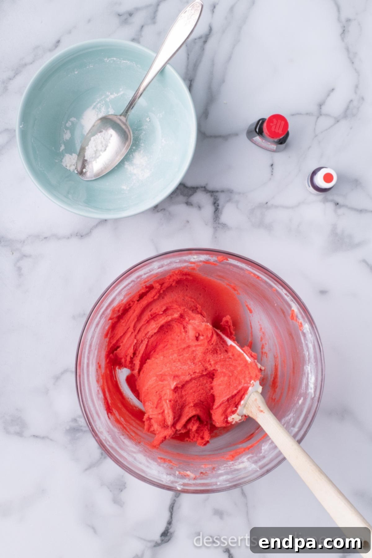 Dark Chocolate-Dipped Peppermint Cookie Delights 6 Red food coloring and peppermint extract being added to the cookie dough.