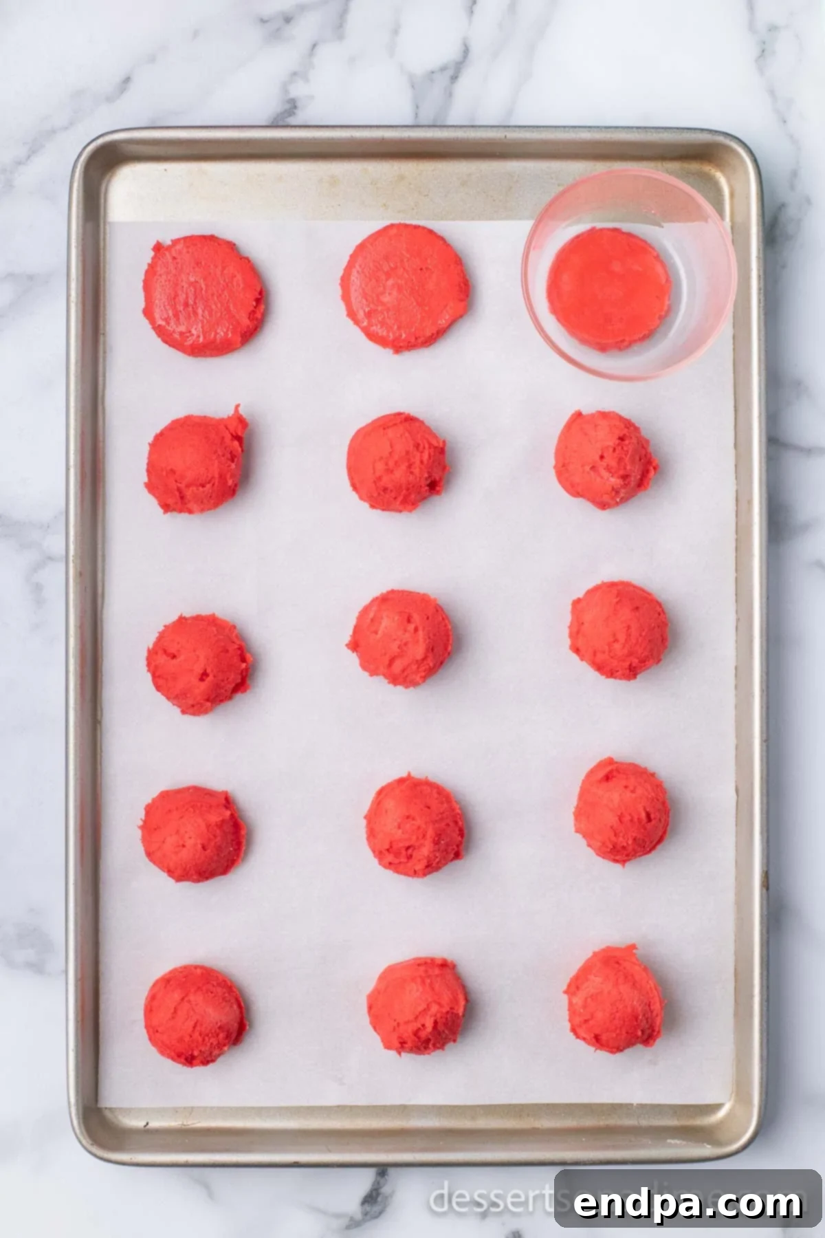 Dark Chocolate-Dipped Peppermint Cookie Delights 8 A glass pressing down on a ball of cookie dough.