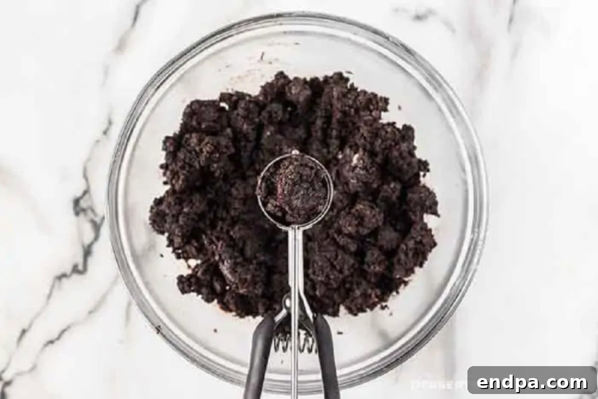 Decadent No-Bake Oreo Truffles 3 Bowl of crushed Oreo cookies combined with cream cheese, forming a dough