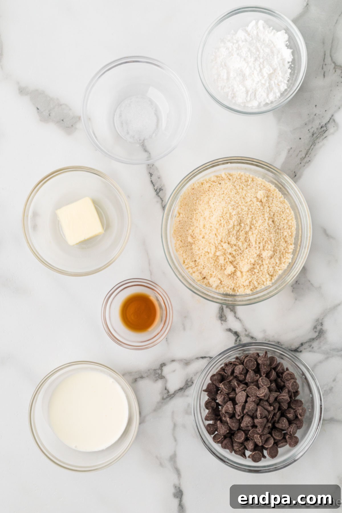 Keto Cookie Dough Bliss 3 A selection of high-quality keto ingredients including almond flour, Swerve powdered sweetener, unsalted butter, heavy cream, and sugar-free chocolate chips.