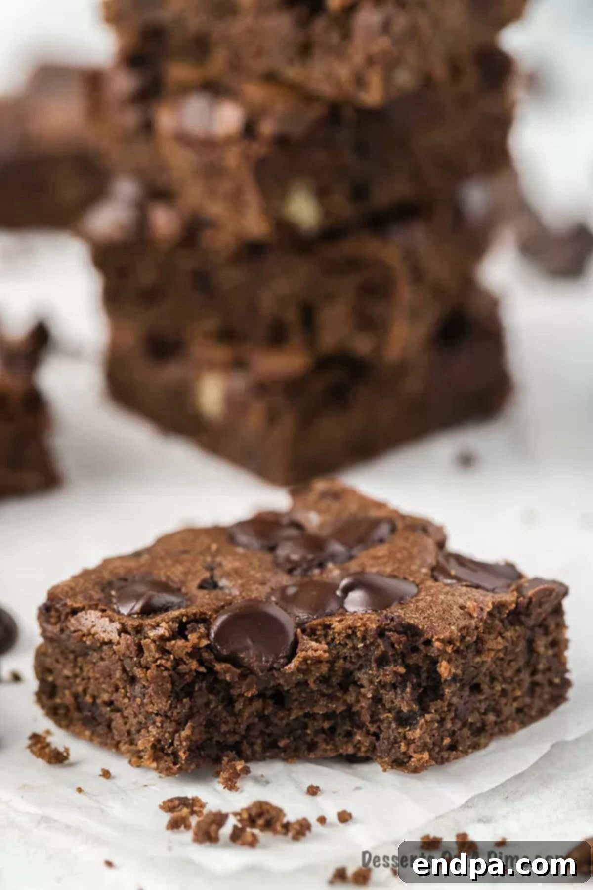 Perfectly baked keto brownies: a simple, healthy, and easy low-carb chocolate brownie recipe with almond flour. Stacked Keto Brownies, showing their rich, fudgy texture and delicious chocolate chips.