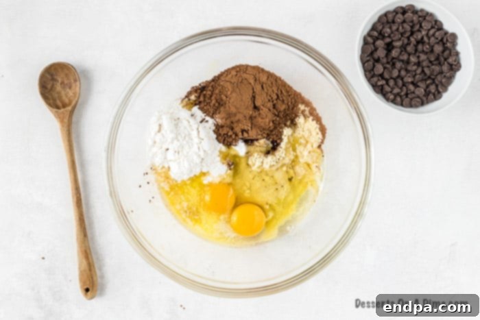 Irresistible Keto Chocolate Fudgies 2 Mixing bowl with keto brownie mixture being gently combined by hand.