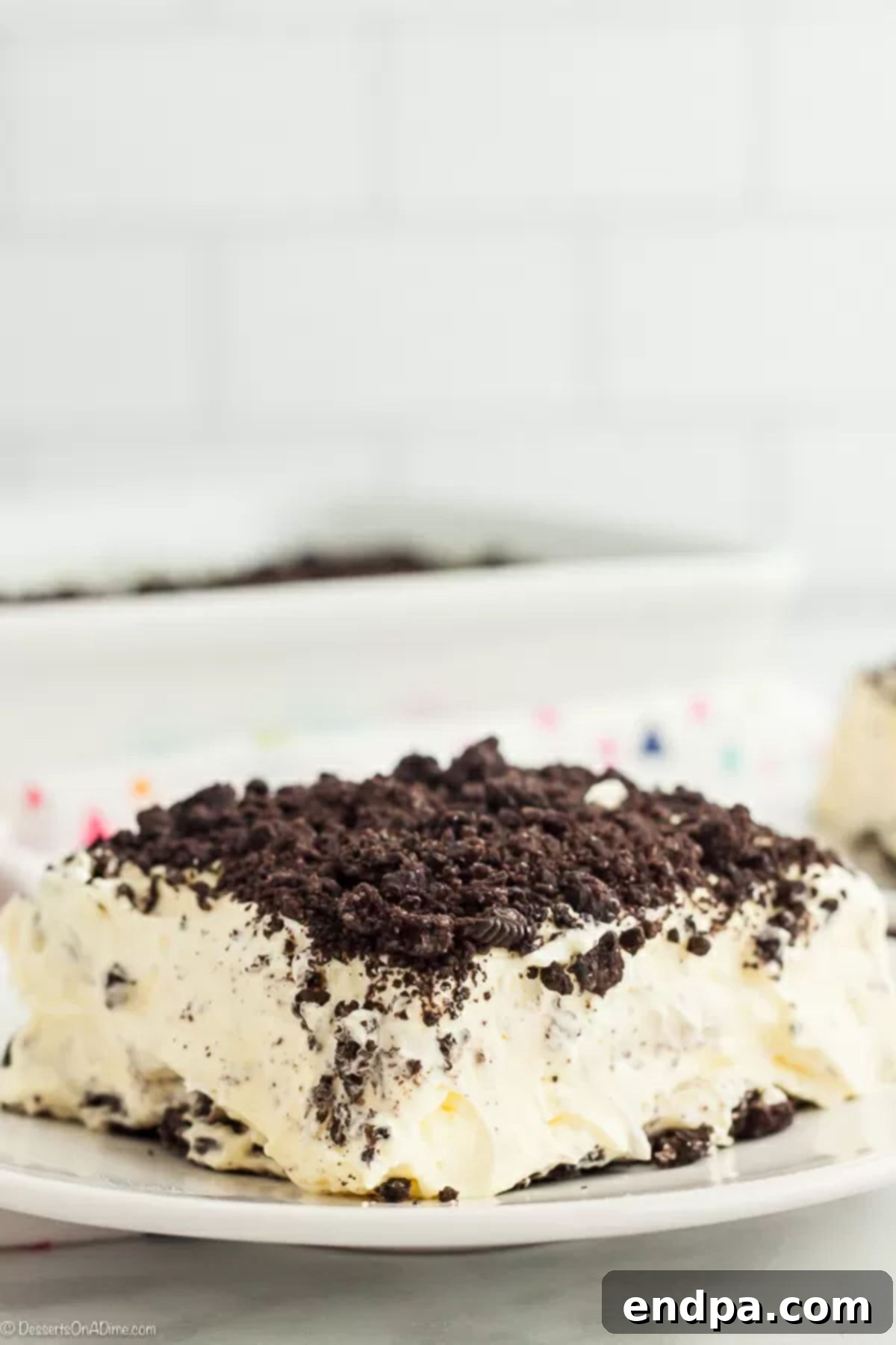 A delectable slice of Oreo Dirt Cake served on a white plate, ready to be enjoyed.