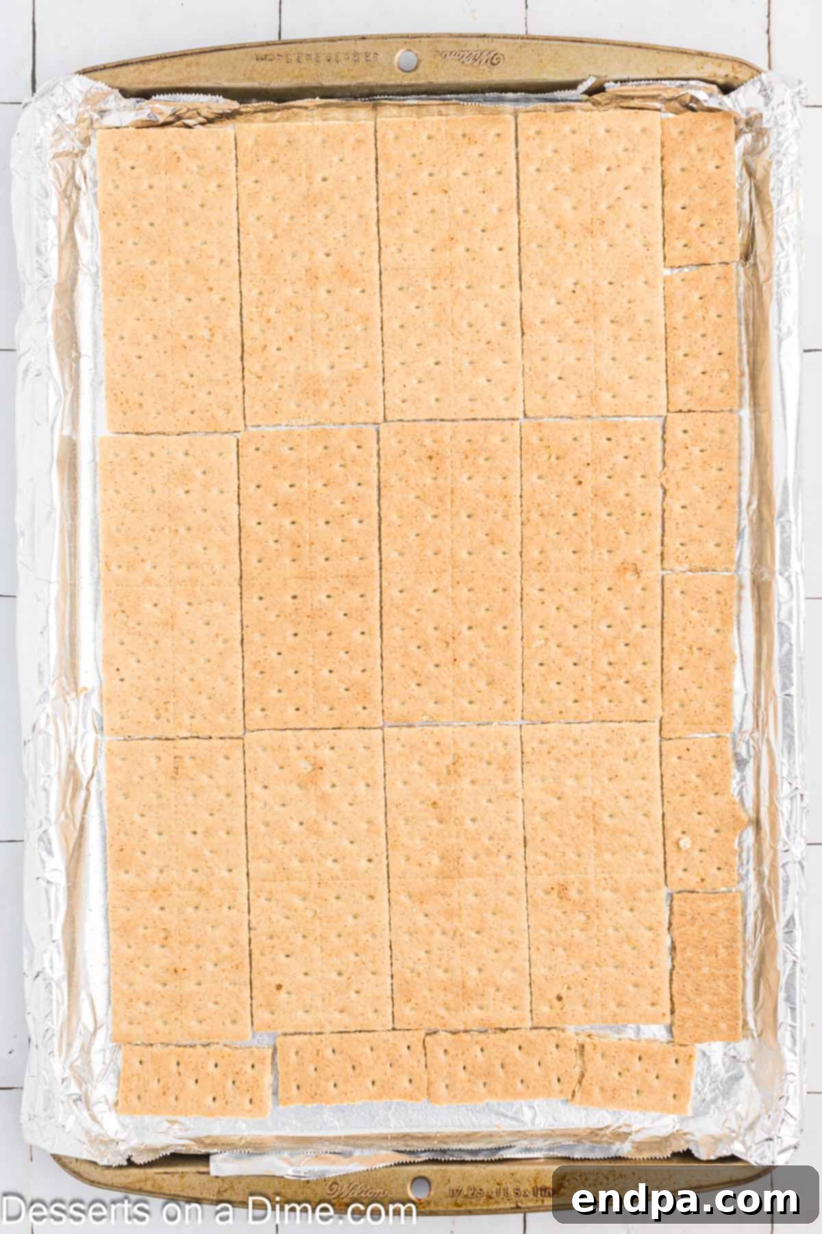 Graham crackers lined on a baking sheet.