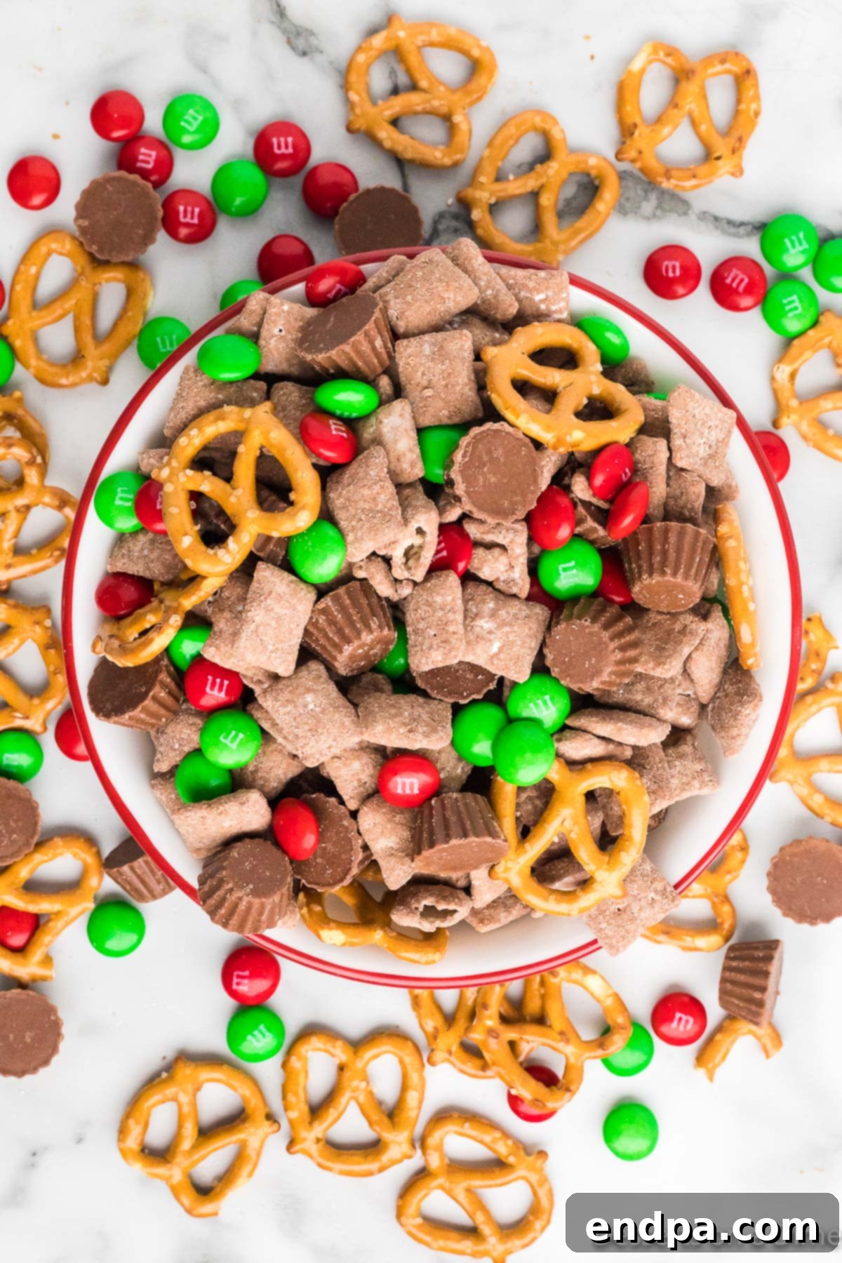 Reindeer Chow in a bowl ready to serve, garnished with festive sprinkles.