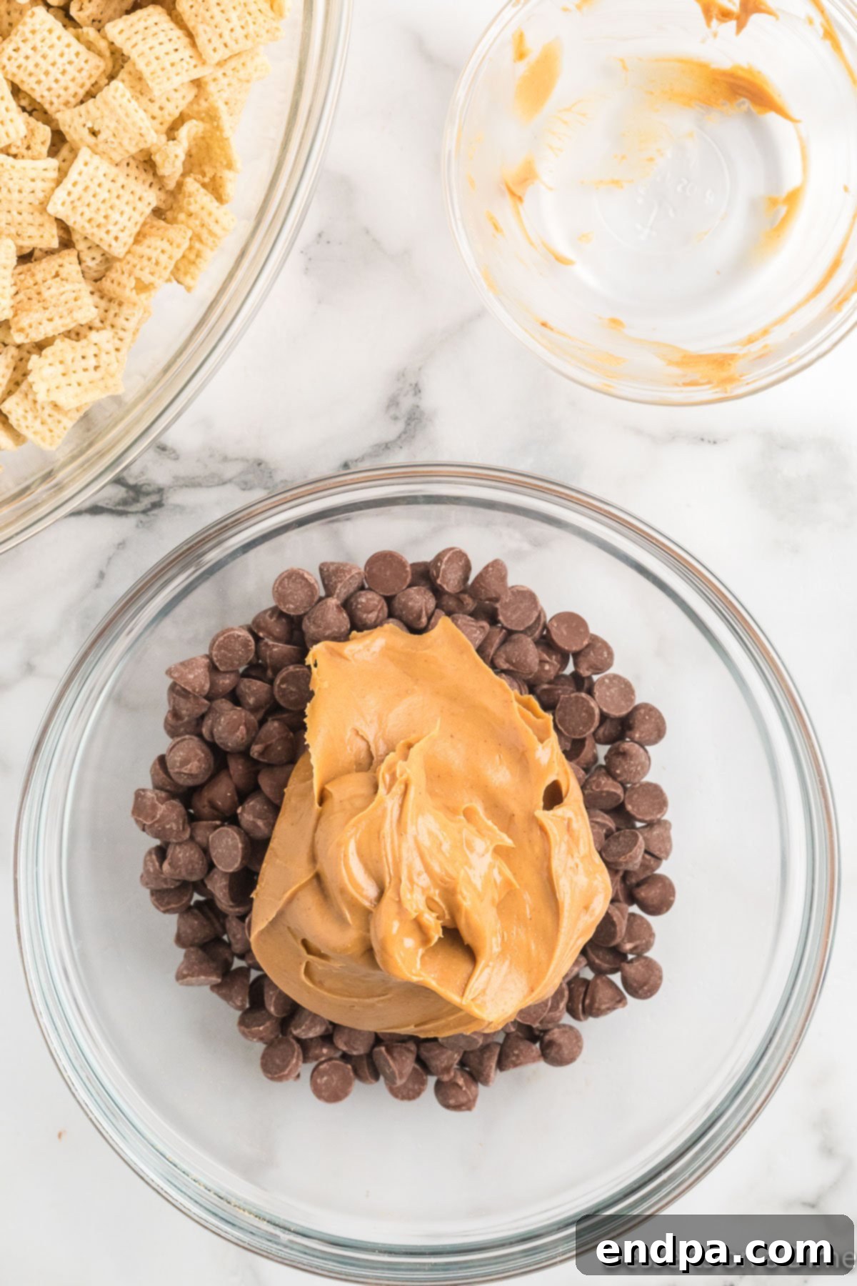 Peanut butter in a bowl with chocolate chips, ready to be melted.