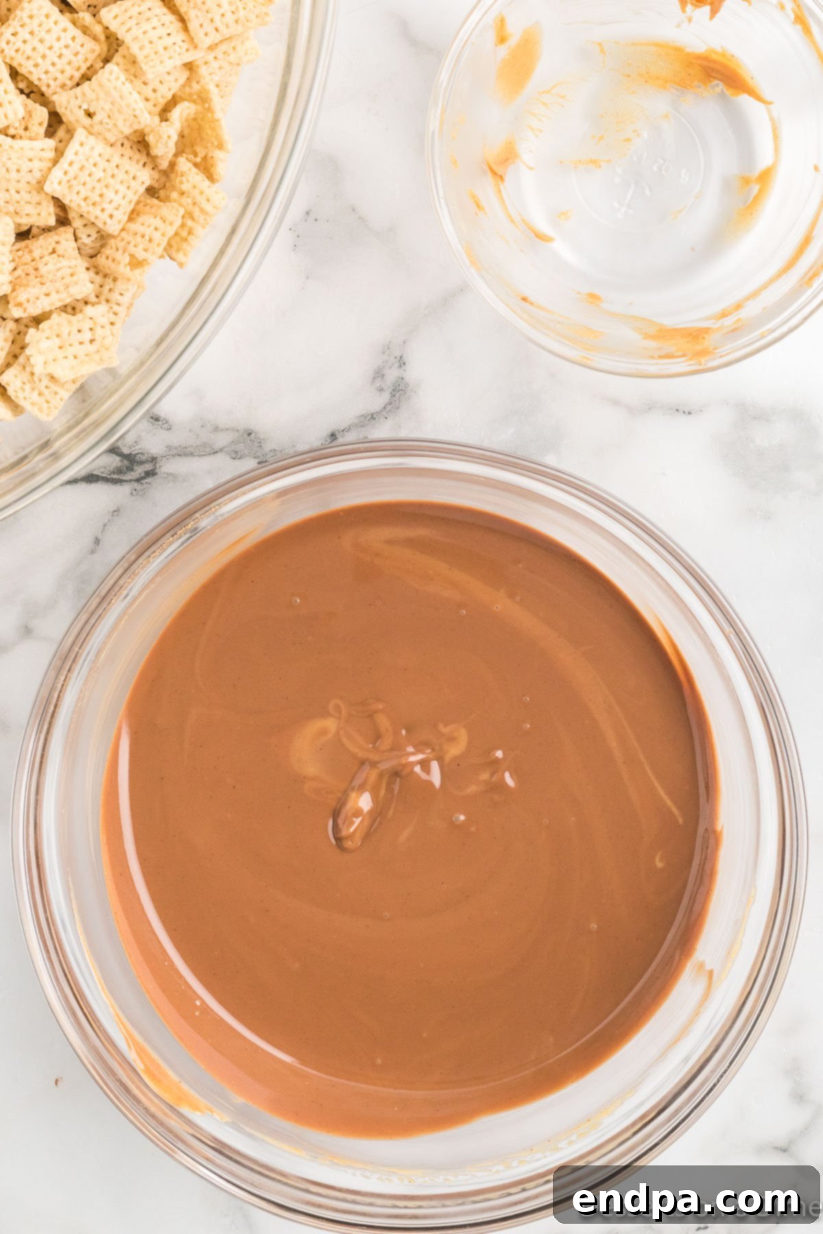 Chocolate and peanut butter melted together into a smooth, glossy mixture.