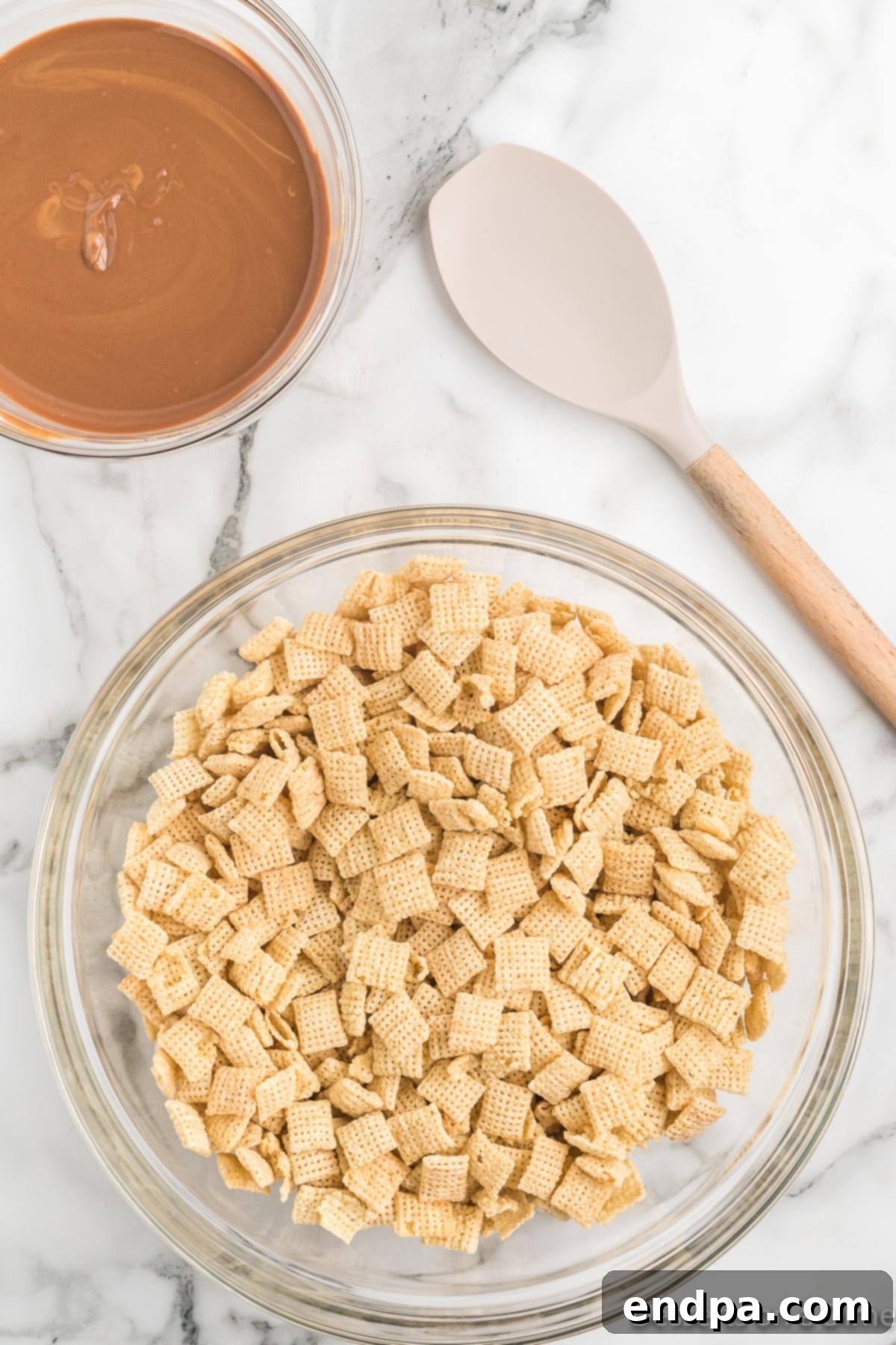 Chex cereal in a large mixing bowl, ready for coating.