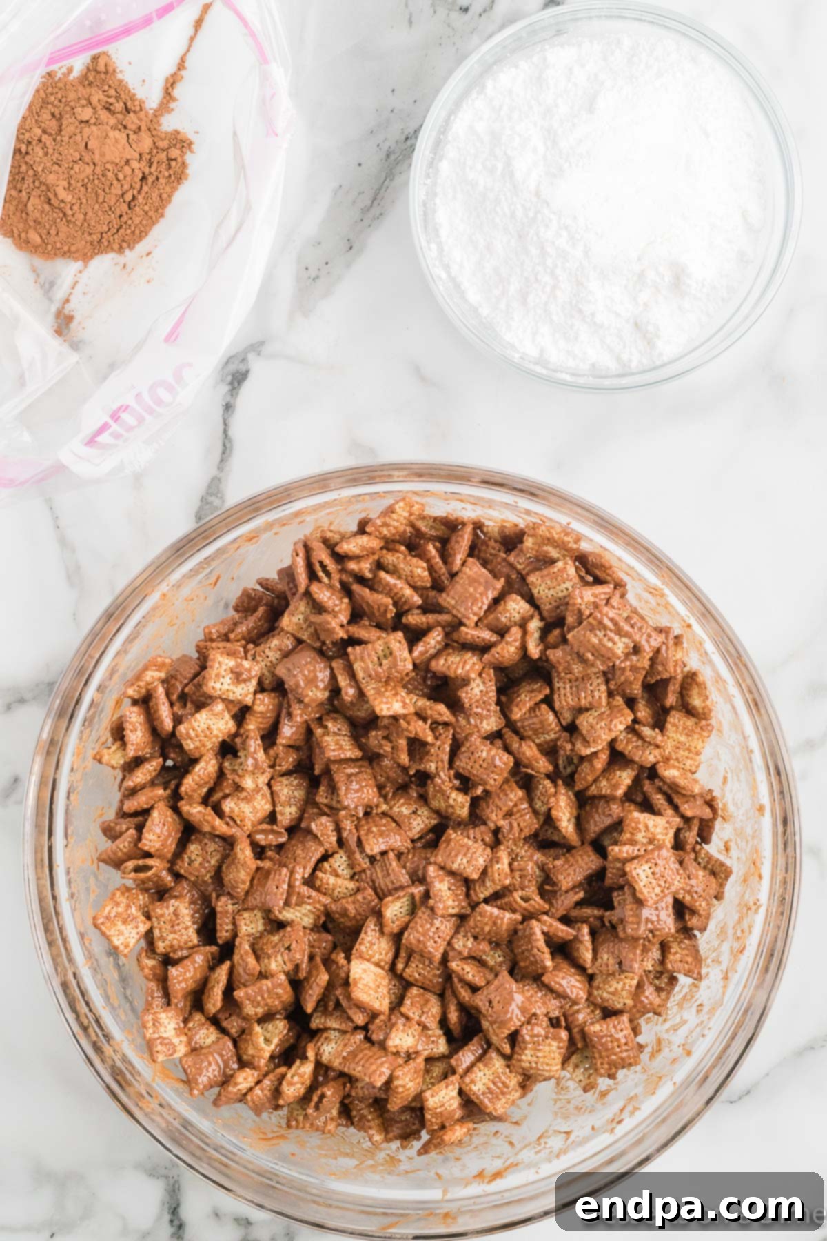 Cereal coated completely in the chocolate peanut butter mixture using a spatula.