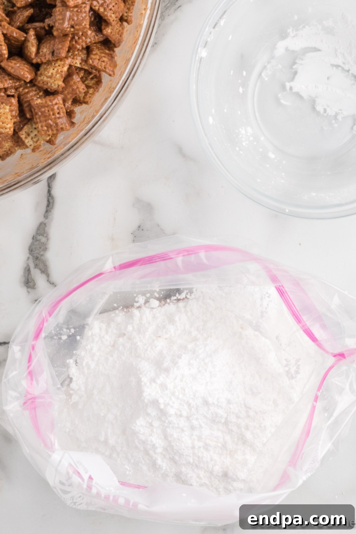 Powdered sugar and cocoa powder in a gallon-sized ziplock bag.