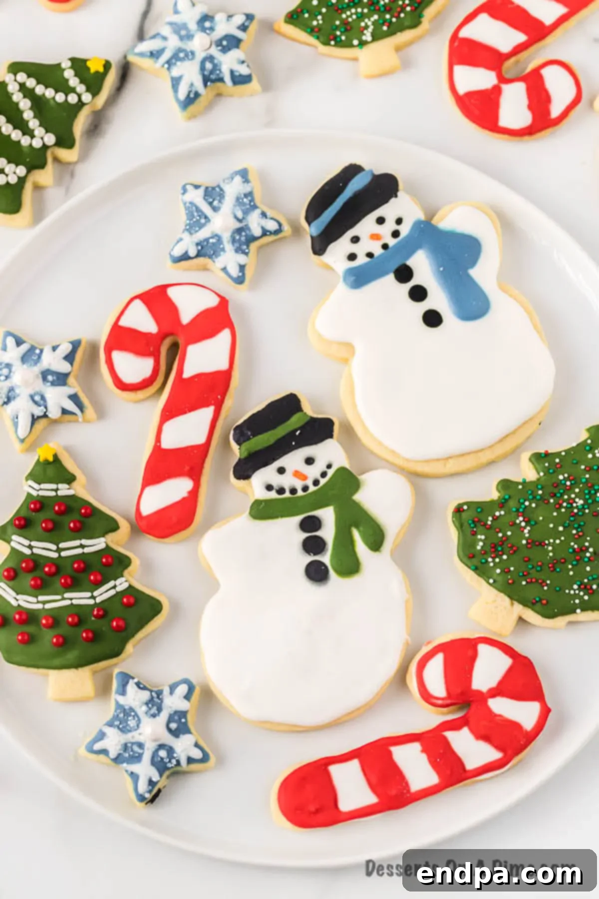 Beautifully decorated Christmas Sugar Cookies arranged on a festive plate, showcasing various holiday shapes and colorful royal icing.