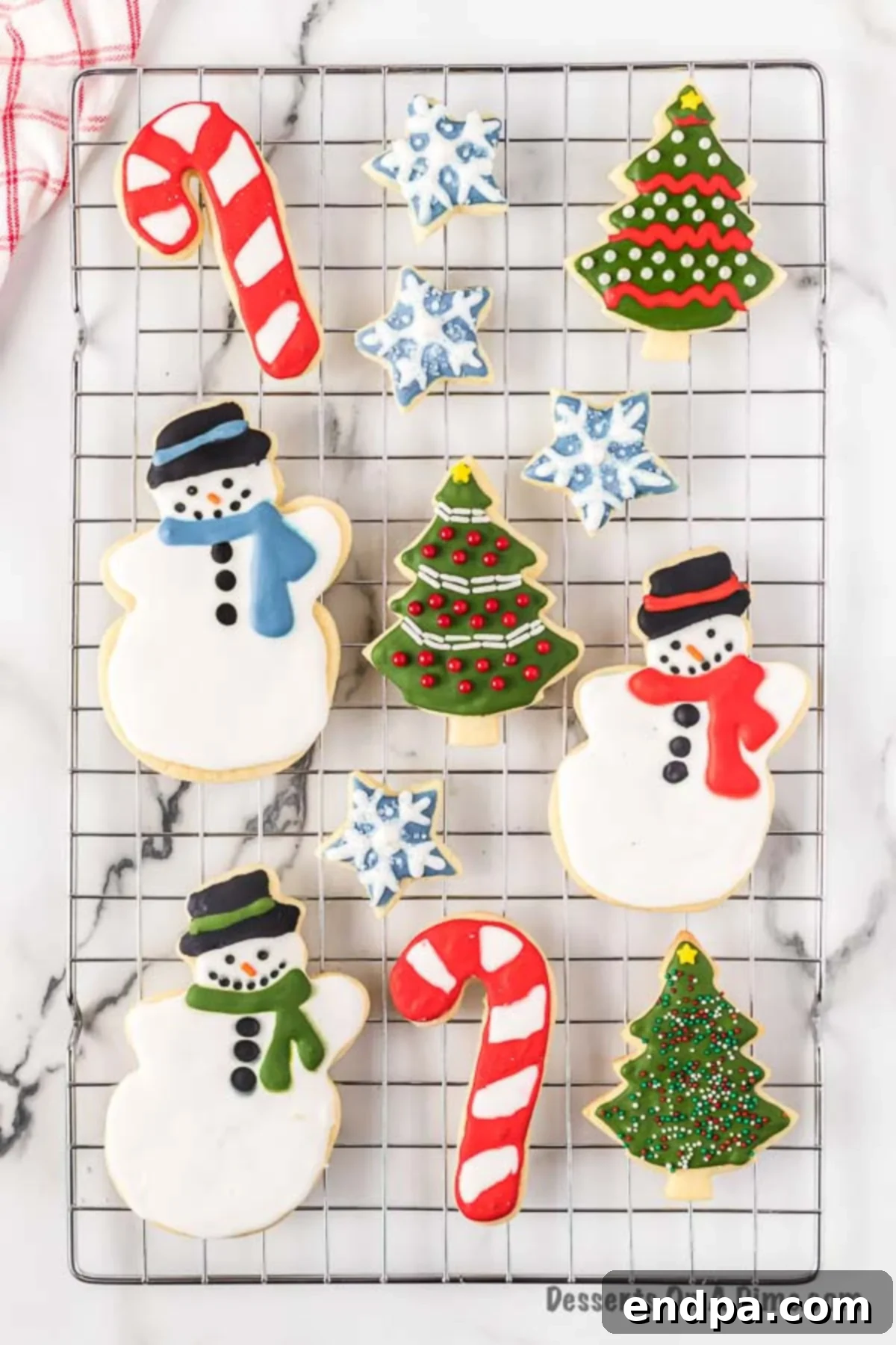 A wire rack filled with beautifully decorated Christmas Sugar Cookies, some still drying.
