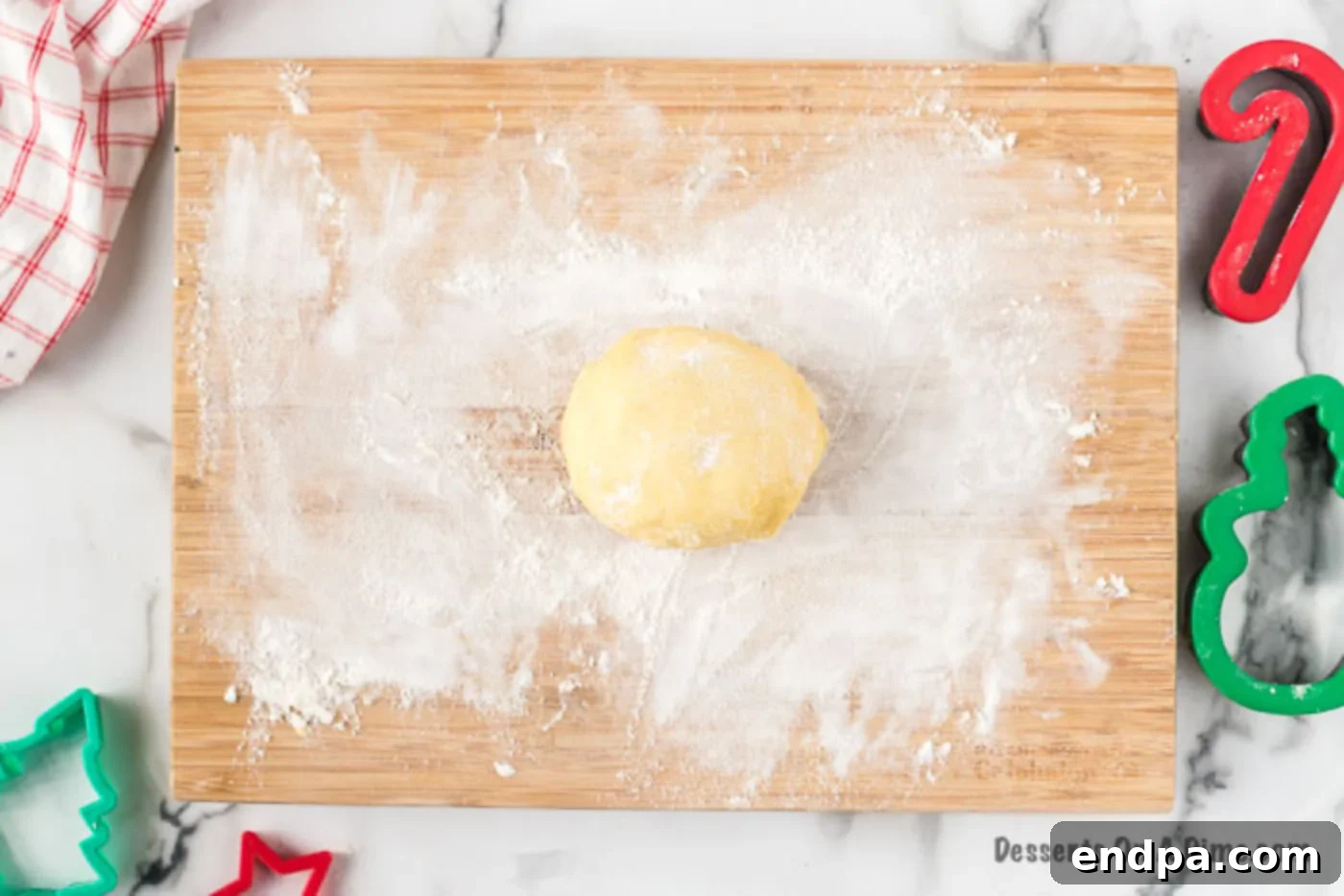 Floured surface with cookie dough, ready for rolling.