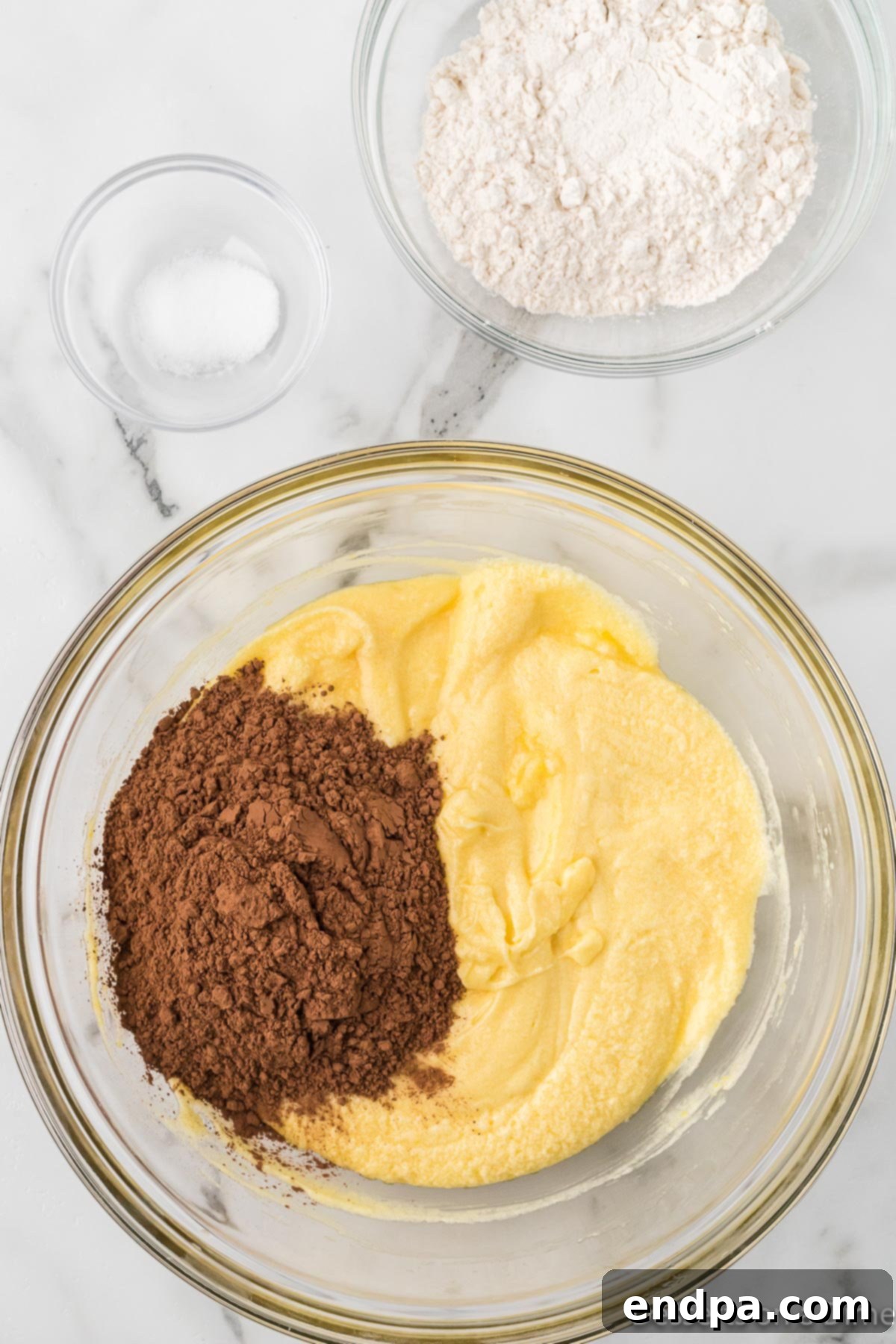 Sweetheart Brownies 5 Cocoa powder being mixed into the wet brownie batter.