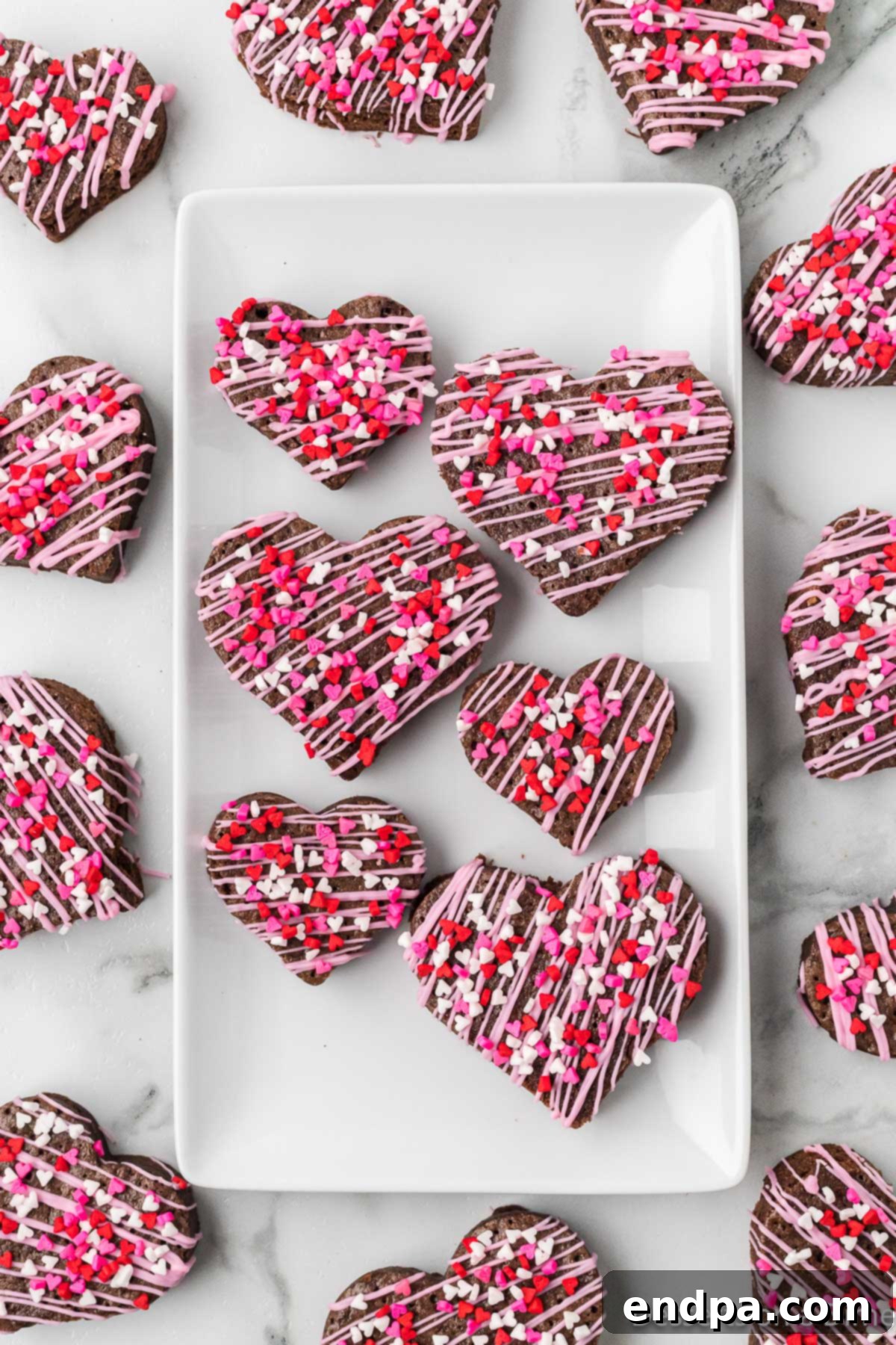 Sweetheart Brownies 10 A platter filled with freshly decorated heart-shaped brownies, ready for serving.