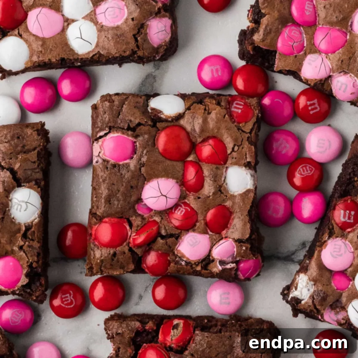 A top-down view of a plate of Valentine's Day Brownies, showing their rich texture and festive M&M's.