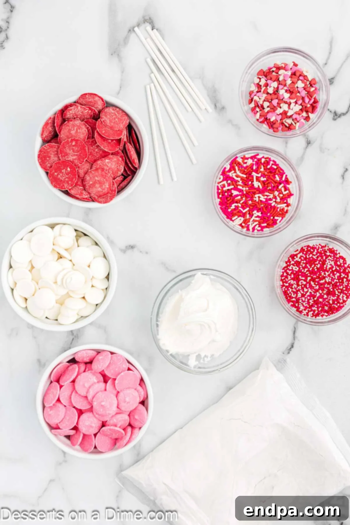 Ingredients for recipe - cake mix, frosting, candy melts, sprinkles and lollipop sticks. 
