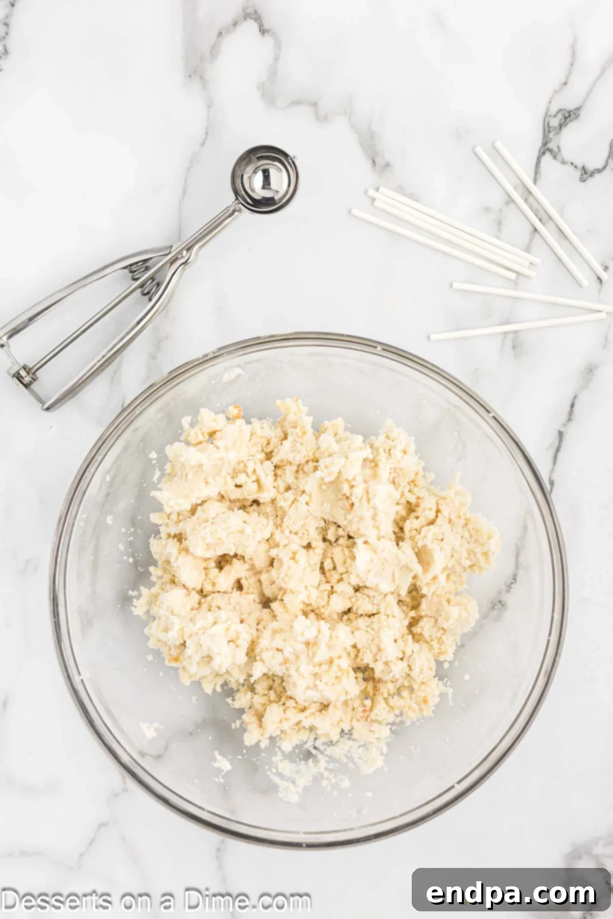 Frosting added to bowl with cake. 