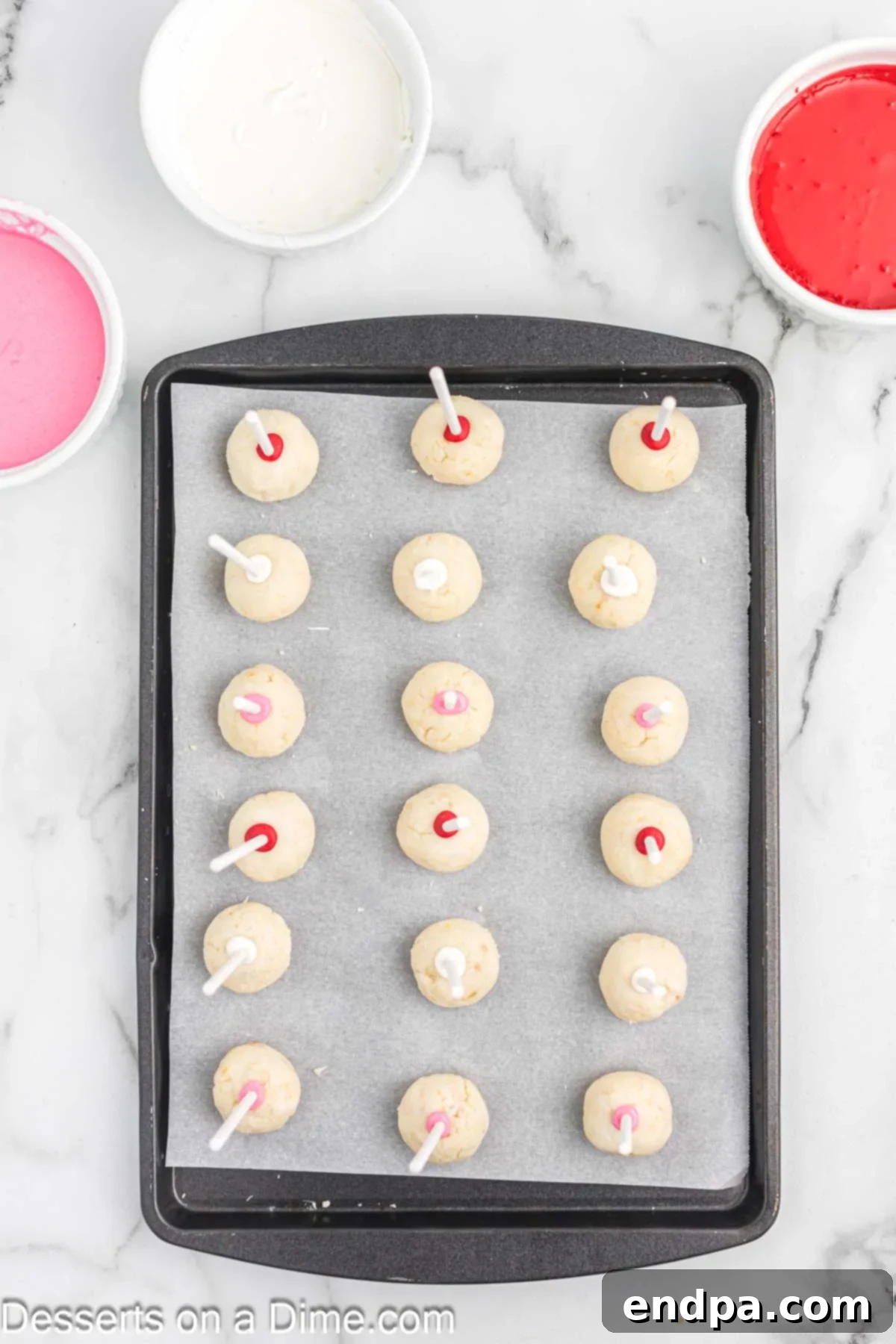 Sticks added to each cake ball and placed on baking sheet. 