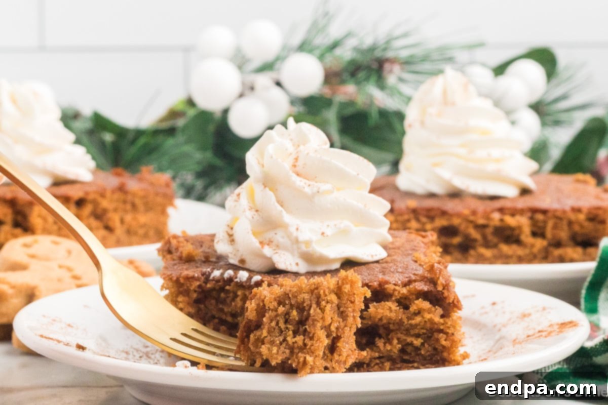 A full, uncut gingerbread cake, moist and golden brown, resting on a serving platter or board, waiting to be sliced and enjoyed.