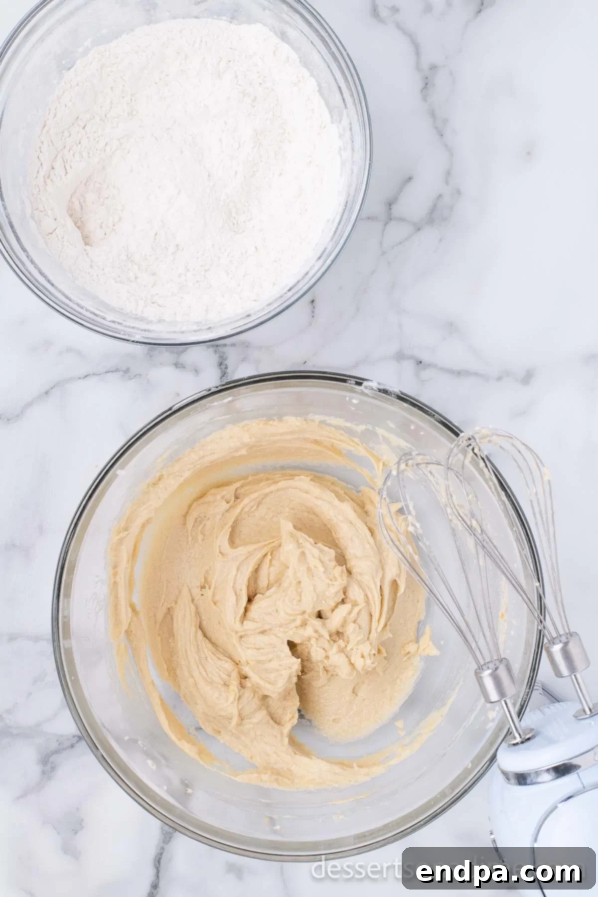 Heartfelt Chocolate Chip Bites 6 Dry ingredients (flour, salt, baking soda, baking powder) are being gently mixed into the wet ingredients to form cookie dough.