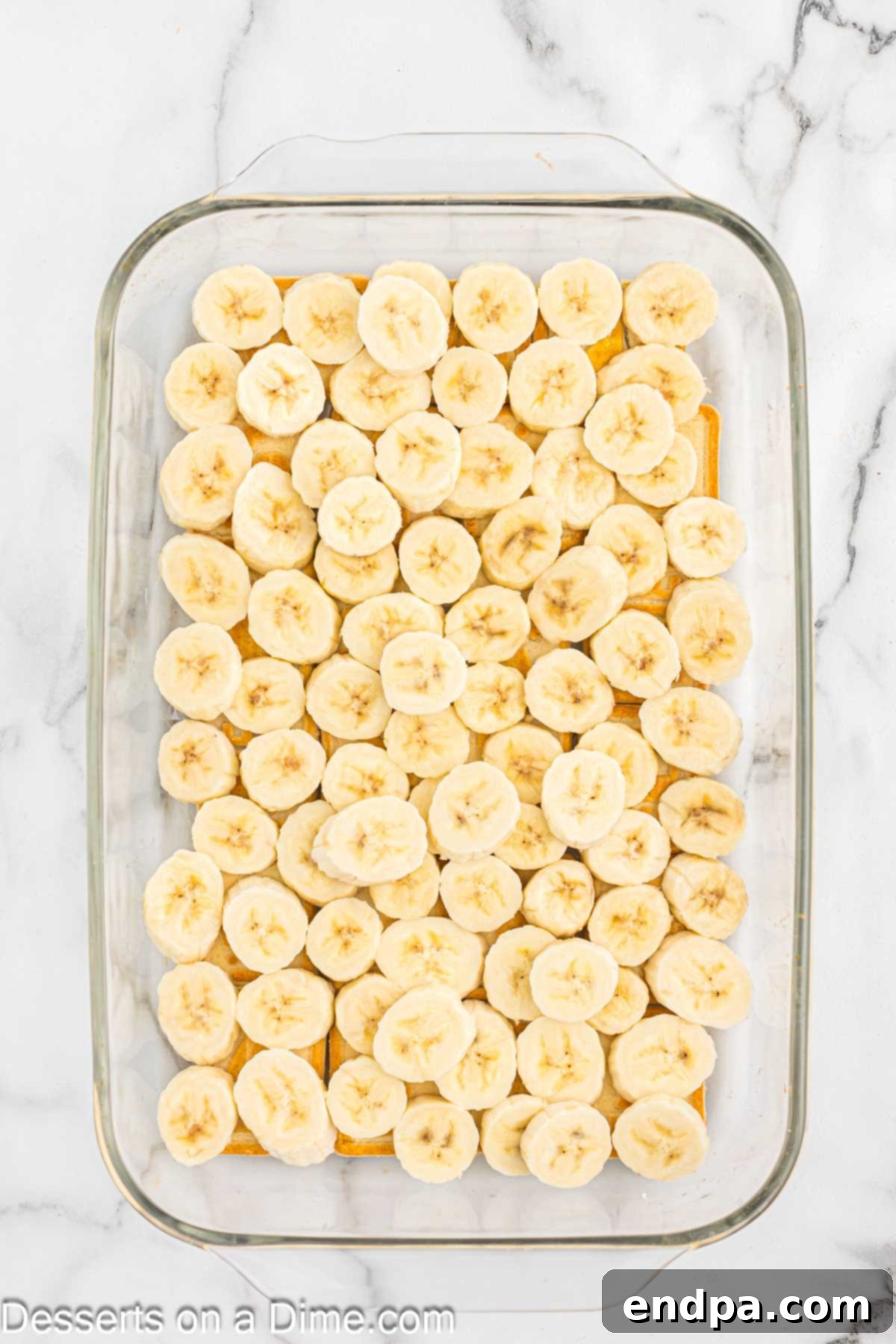 Paula Deen's Southern Banana Pudding 5 Bananas on top of cookies.