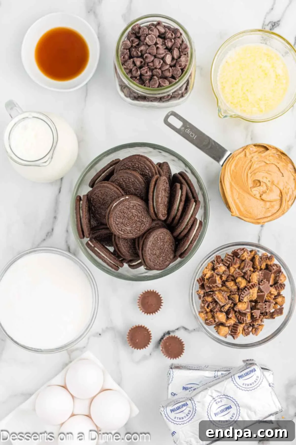 Ingredients for recipe - oreo cookies, butter, cream cheese, sugar, vanilla, peanut butter, eggs, heavy cream, peanut butter cups, heavy whipping cream, chocolate chips. 