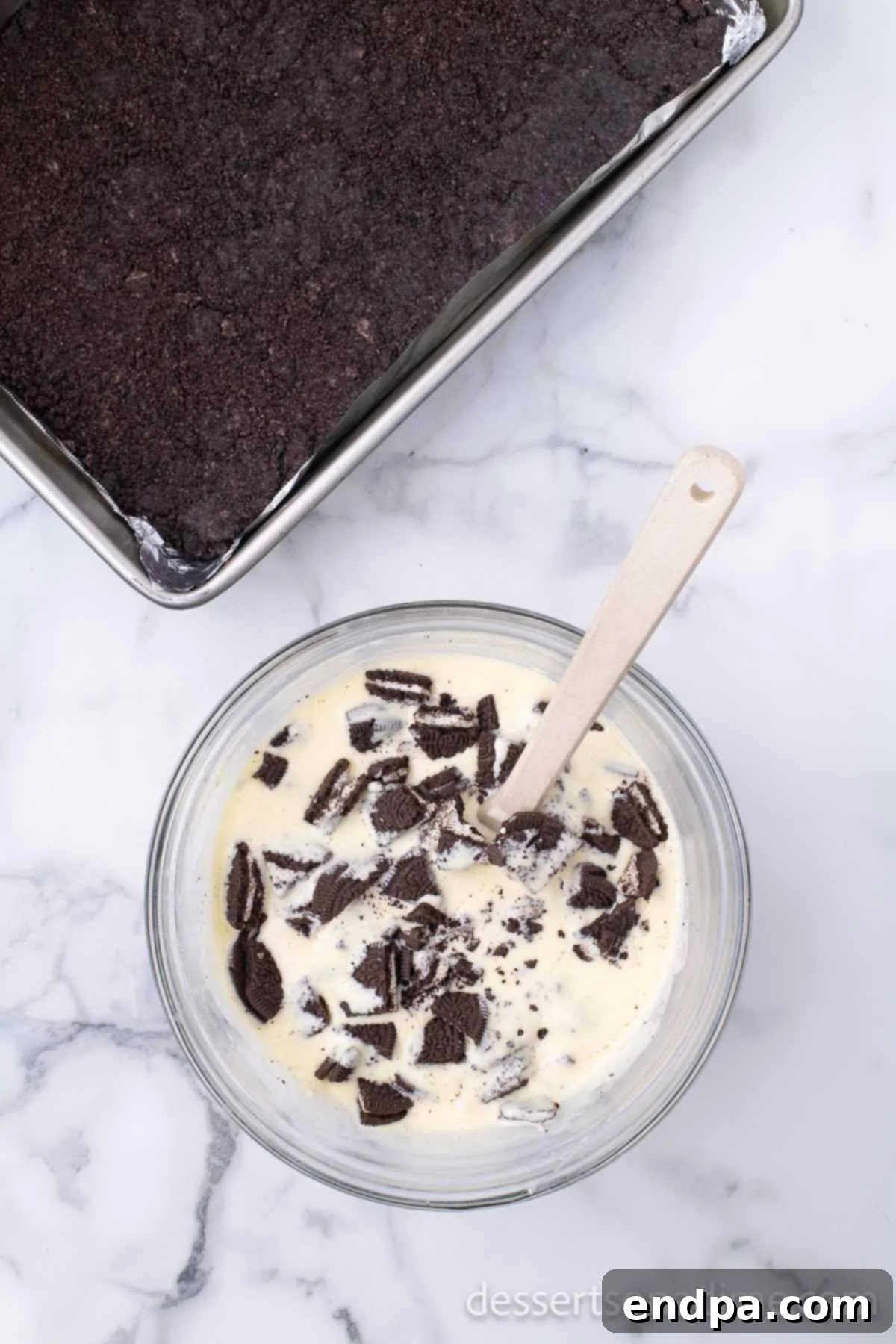 Heavenly Oreo Cheesecake Treats 9 Chopped Oreo pieces being folded into the cheesecake mixture.