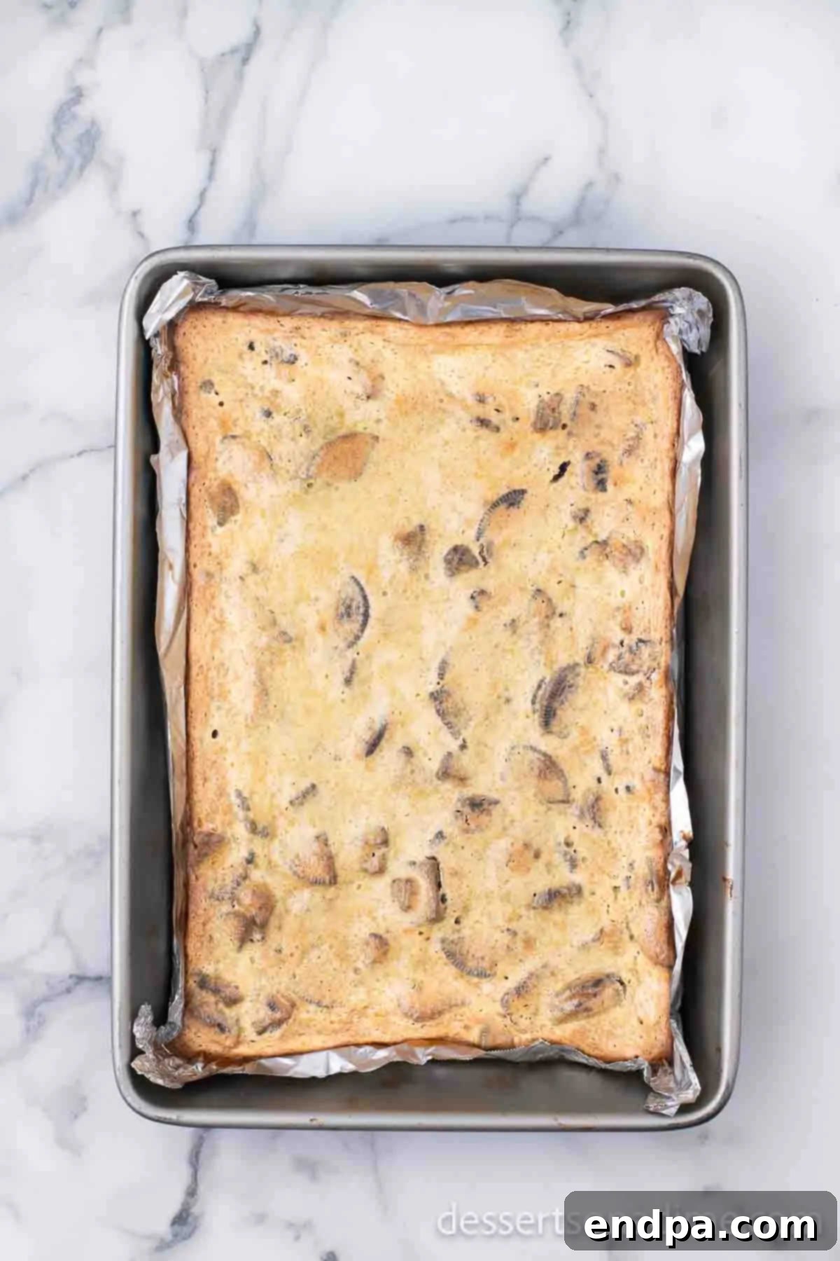Heavenly Oreo Cheesecake Treats 11 Baked Oreo Cheesecake Bars cooling on a wire rack.