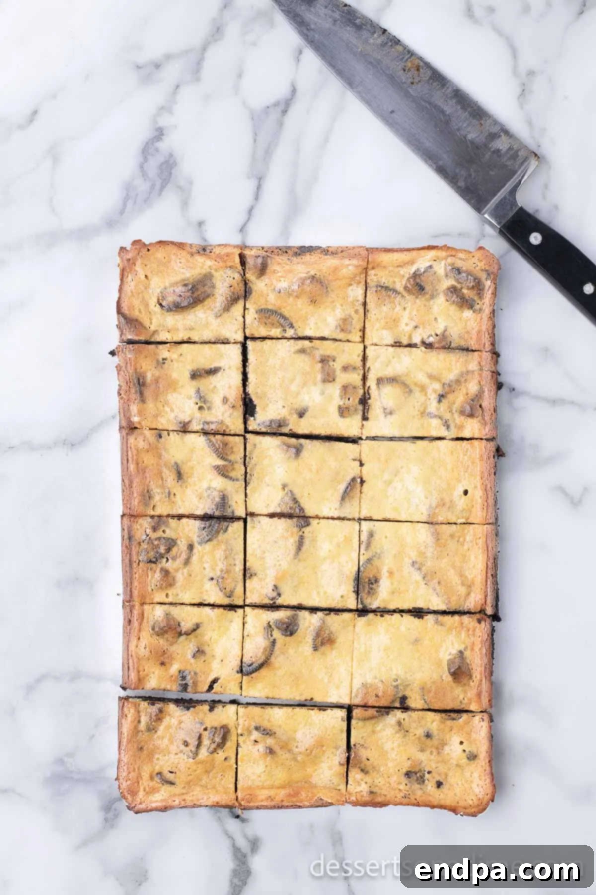 Heavenly Oreo Cheesecake Treats 12 Oreo Cheesecake Bars cut into squares and ready to be served.