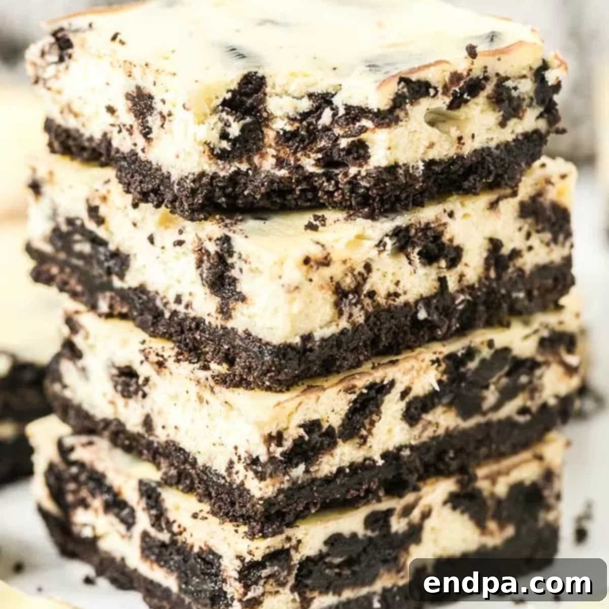 Heavenly Oreo Cheesecake Treats 14 A perfectly stacked square of Oreo Cheesecake Bar, ready to be enjoyed.