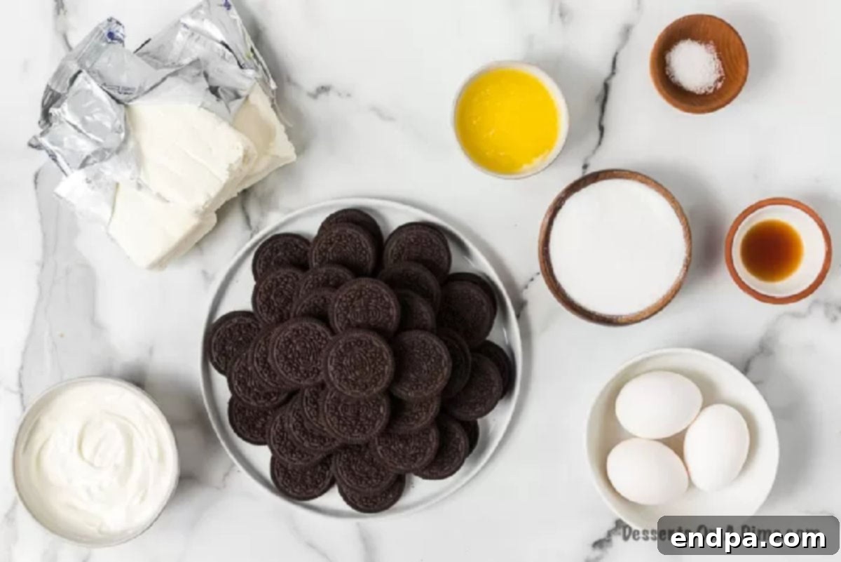 Oreo Cheesecake Bars: A delightful fusion of classic Oreo cookies and creamy cheesecake, perfect for any occasion. This easy-to-make dessert is packed with chocolatey goodness, offering a simple yet elegant treat. Enjoy these Cookies and Cream Cheesecake Bars for an unforgettable dessert. A collection of ingredients laid out, including Oreo cookies, cream cheese, sugar, and sour cream, ready for making Oreo Cheesecake Bars.