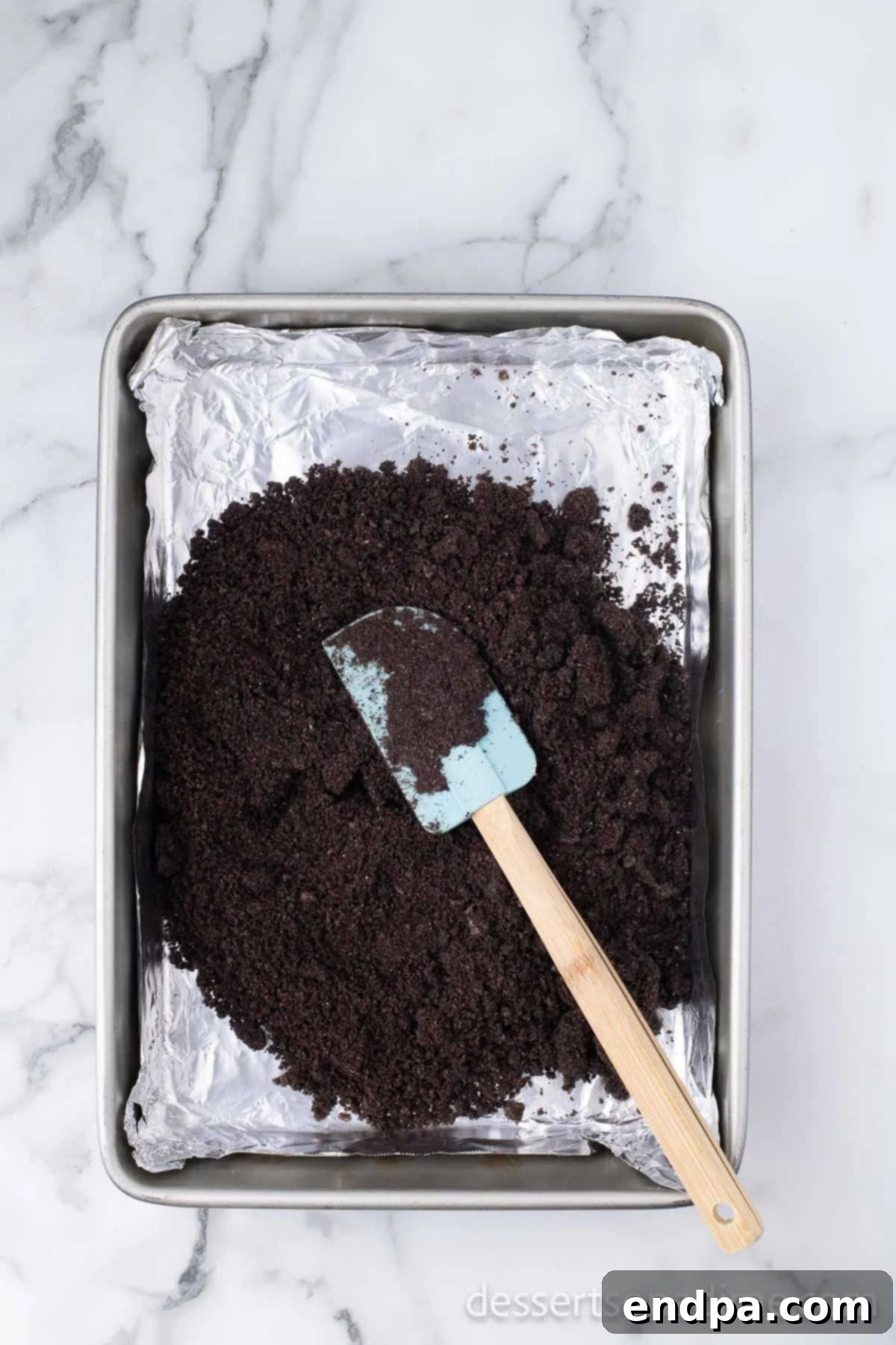 Heavenly Oreo Cheesecake Treats 4 The cookie mixture pressed evenly into the prepared baking pan.