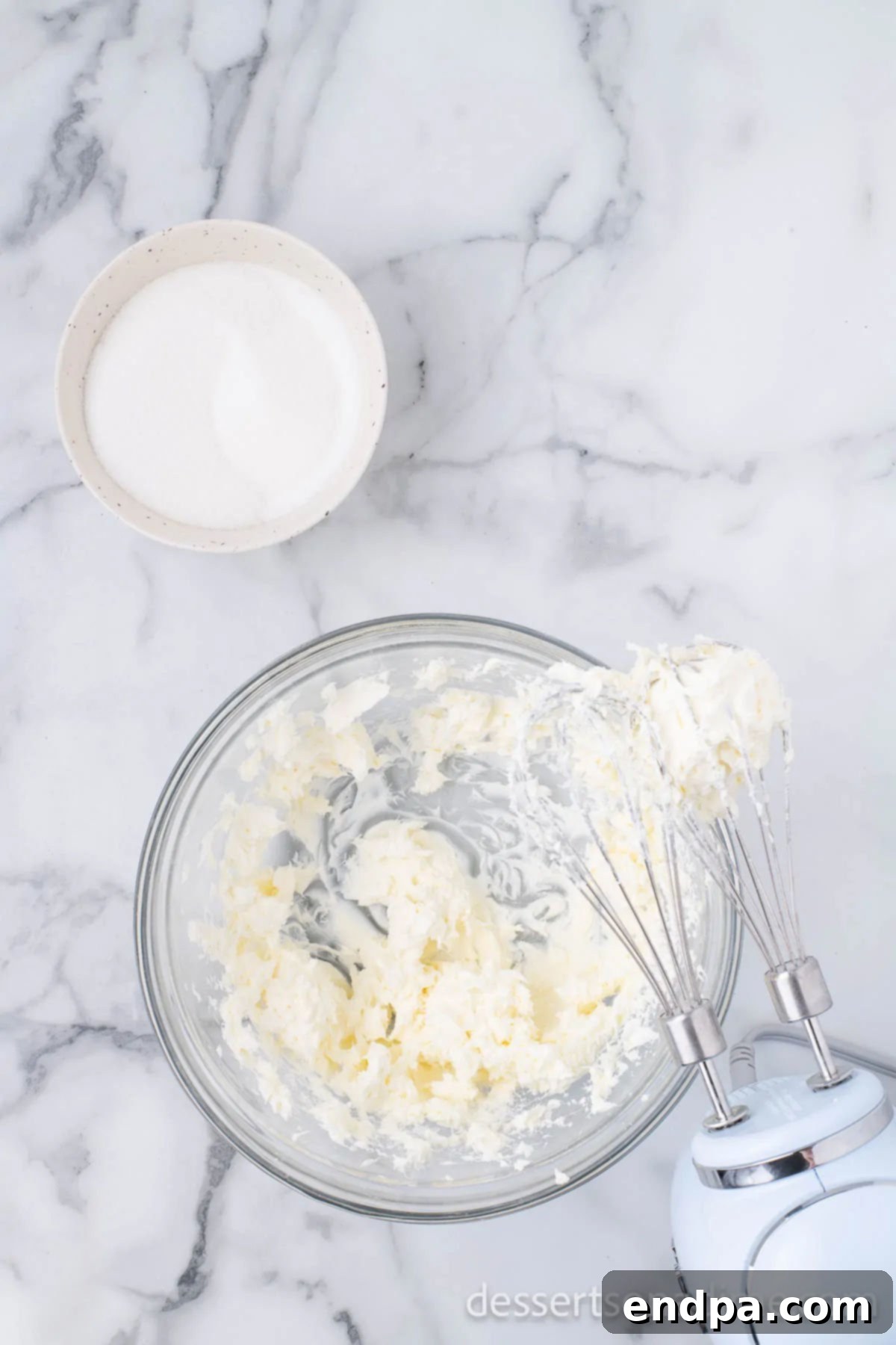 Heavenly Oreo Cheesecake Treats 5 Cream cheese being beaten in a large mixing bowl.