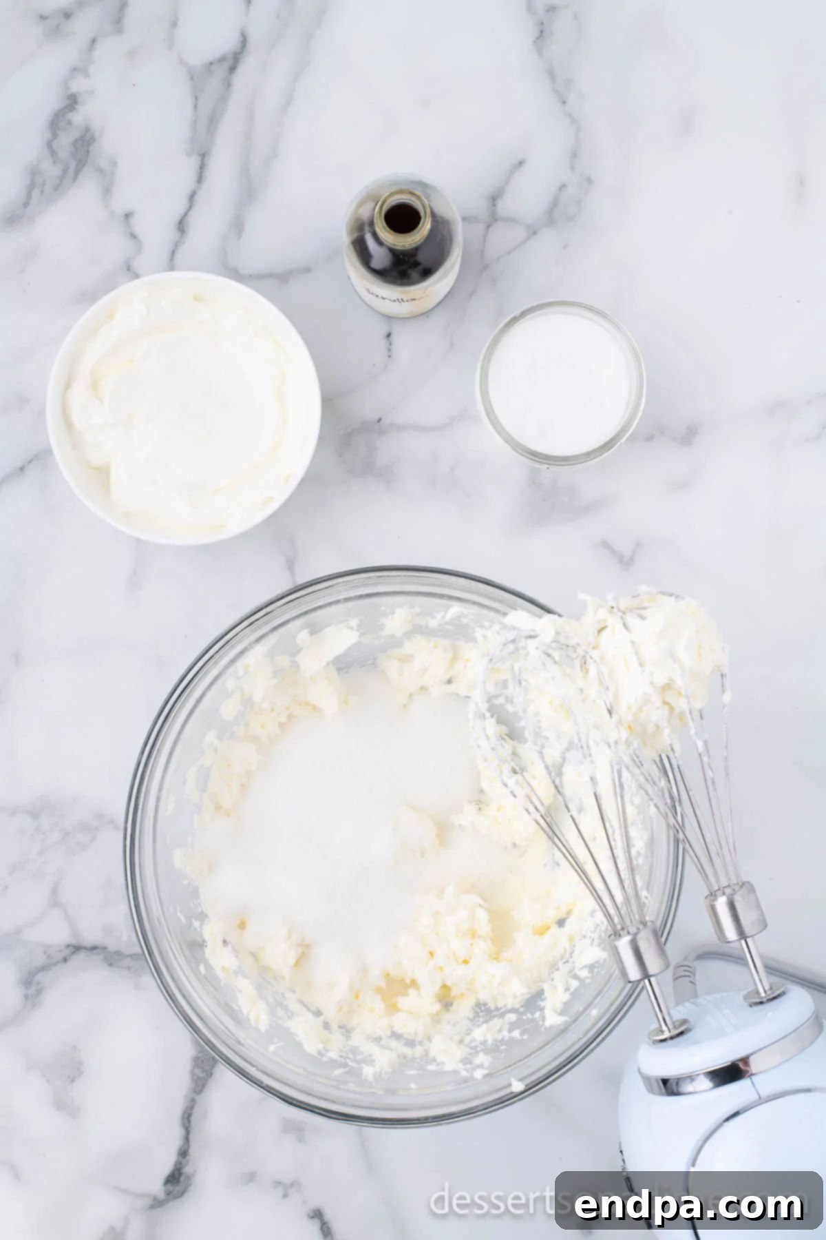 Heavenly Oreo Cheesecake Treats 6 Granulated sugar being added to the cream cheese mixture.