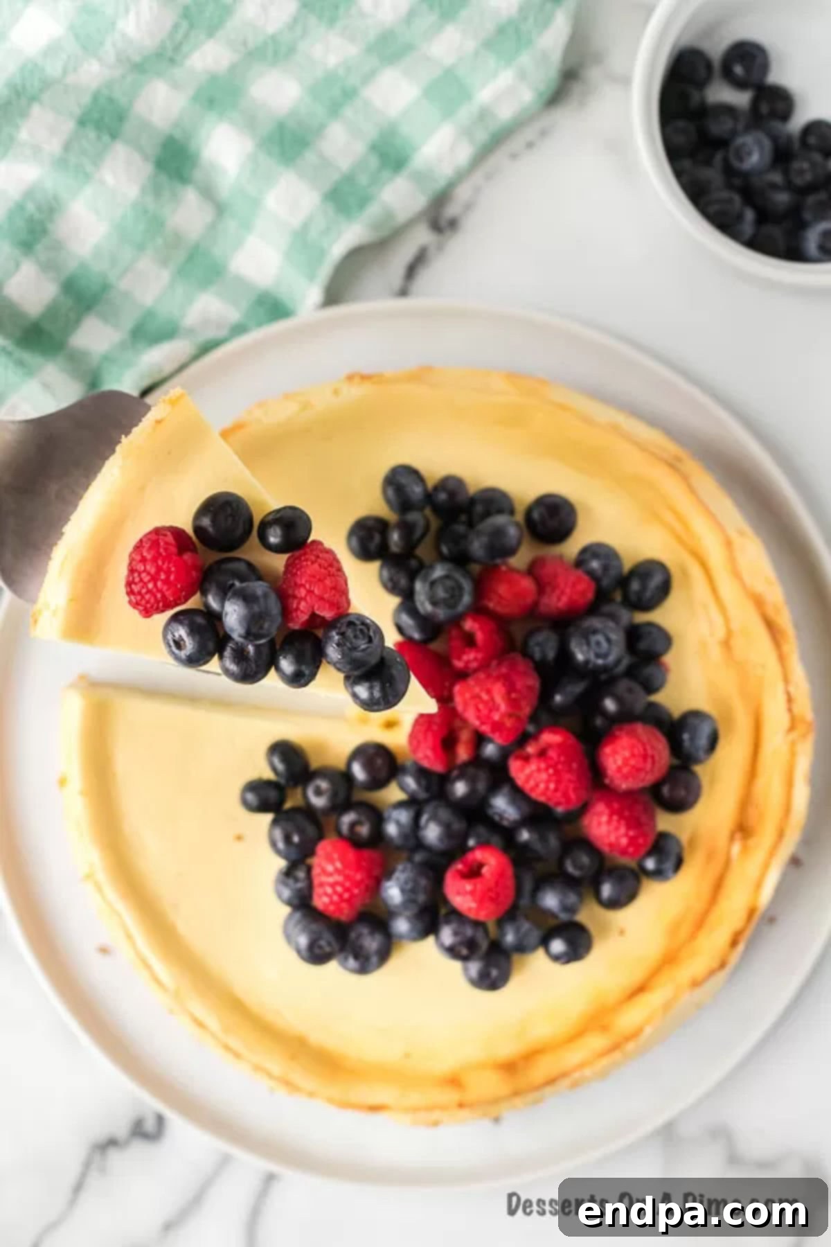 Fresh berries artfully arranged on top of a perfectly baked keto cheesecake.