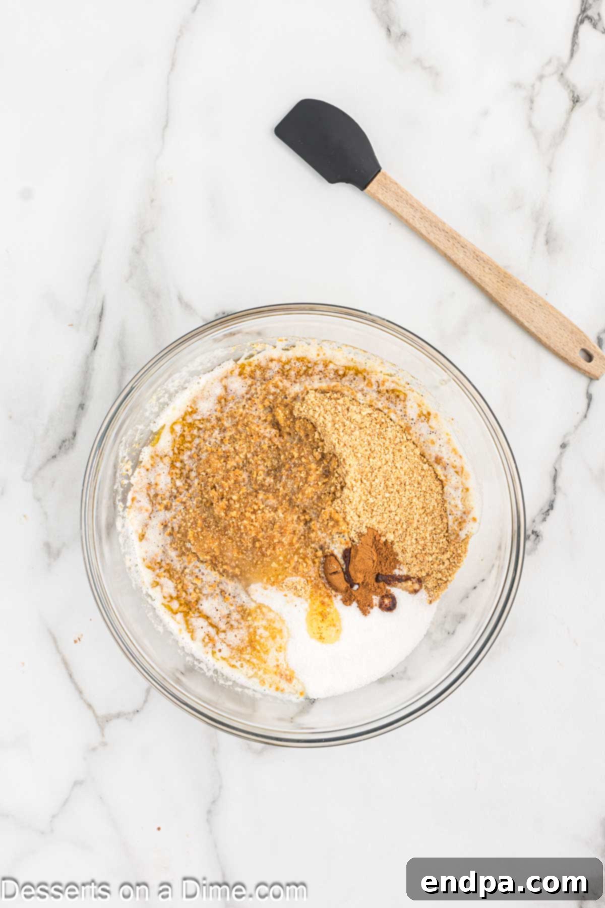 Bowl with melted butter and crust ingredients mixed together.