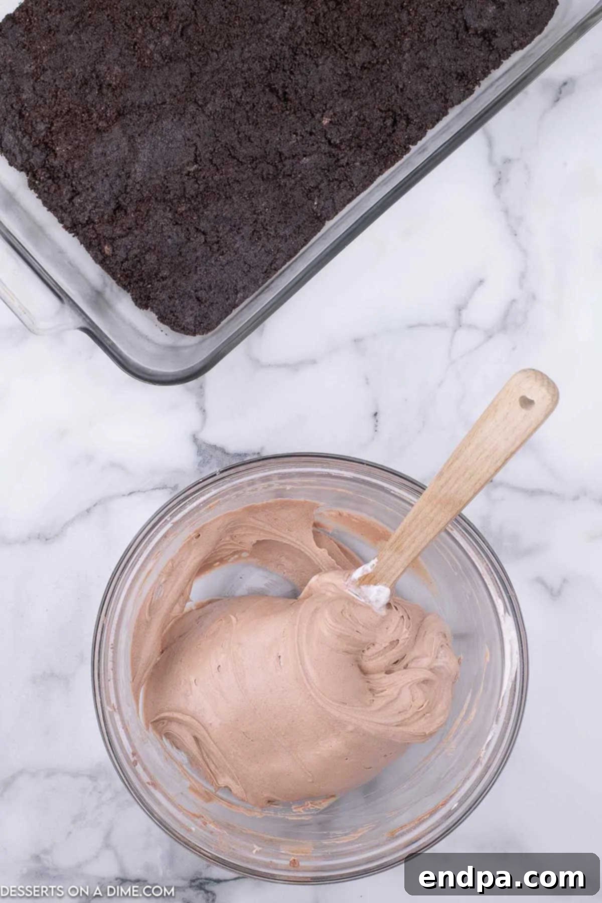 Decadent Hot Cocoa Lasagna 6 Mixing bowl containing the creamy hot chocolate cheesecake mousse layer, showing its smooth consistency.