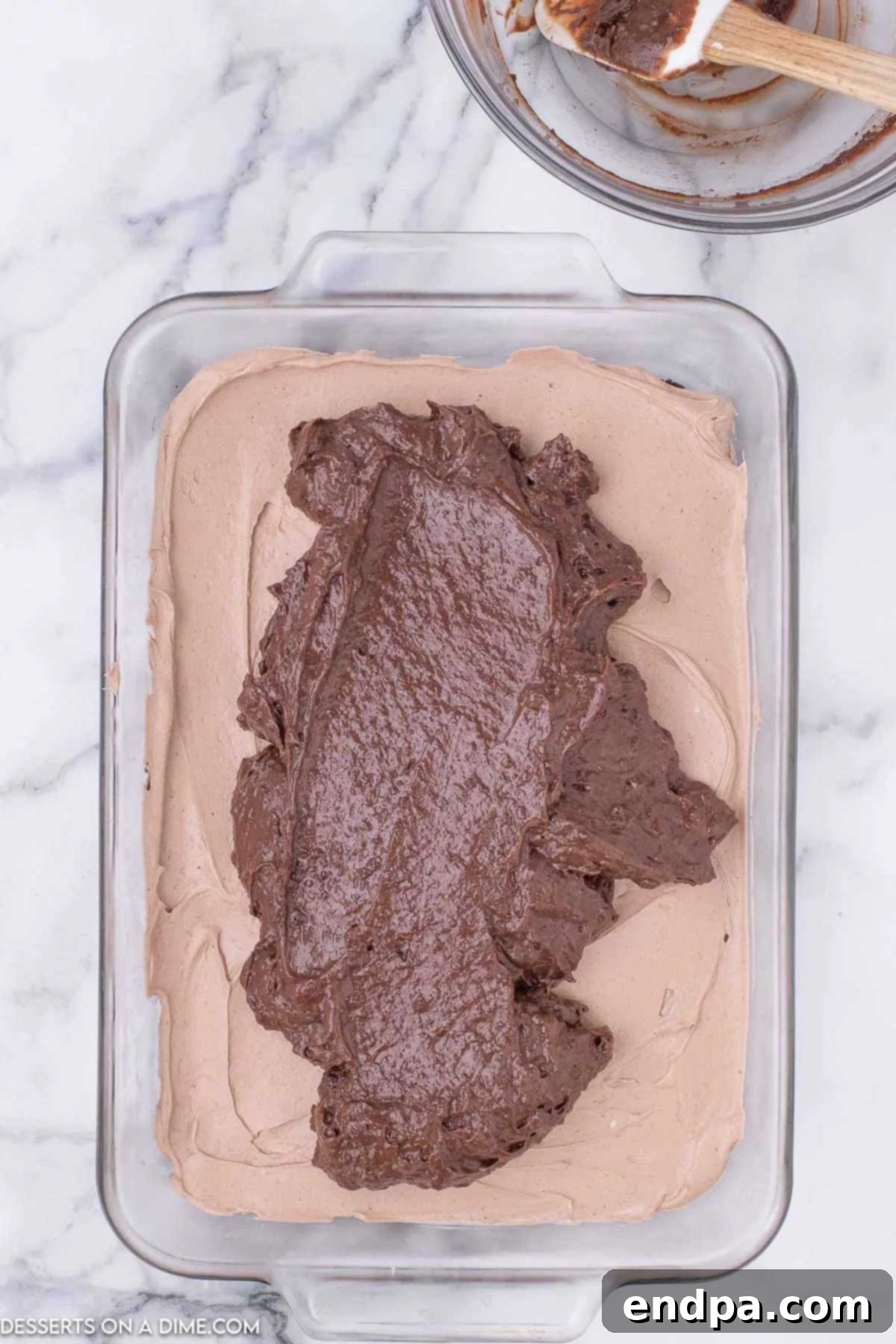 Decadent Hot Cocoa Lasagna 8 The smooth chocolate pudding layer spread over the cheesecake mousse, creating the third layer of the lasagna.